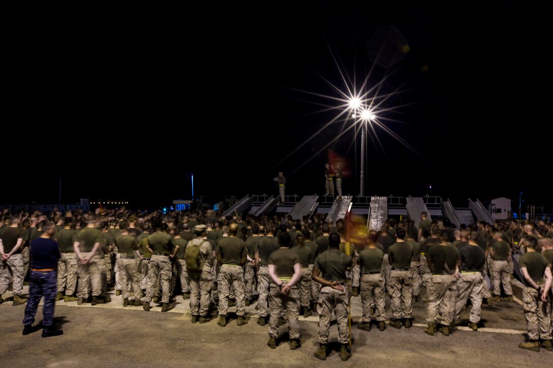 U.S. Marines and sailors assigned to the 26th Marine Expeditionary Unit (MEU) listen to Col. Matthew St. Clair and Sgt. Maj. Todd Parisi, senior leadership of the 26th MEU, after conducting a noncommissioned officer and staff noncommissioned officer run aboard U.S. Naval Station Rota, Spain, Oct. 22, 2013. The 26th MEU is a Marine Air-Ground Task Force forward-deployed to the U.S. 6th Fleet area of responsibility aboard the Kearsarge Amphibious Ready Group serving as a sea-based, expeditionary crisis response force capable of conducting amphibious operations across the full range of military operations. (U.S. Marine Corps photo by Sgt. Christopher Q. Stone, 26th MEU Combat Camera/Released)