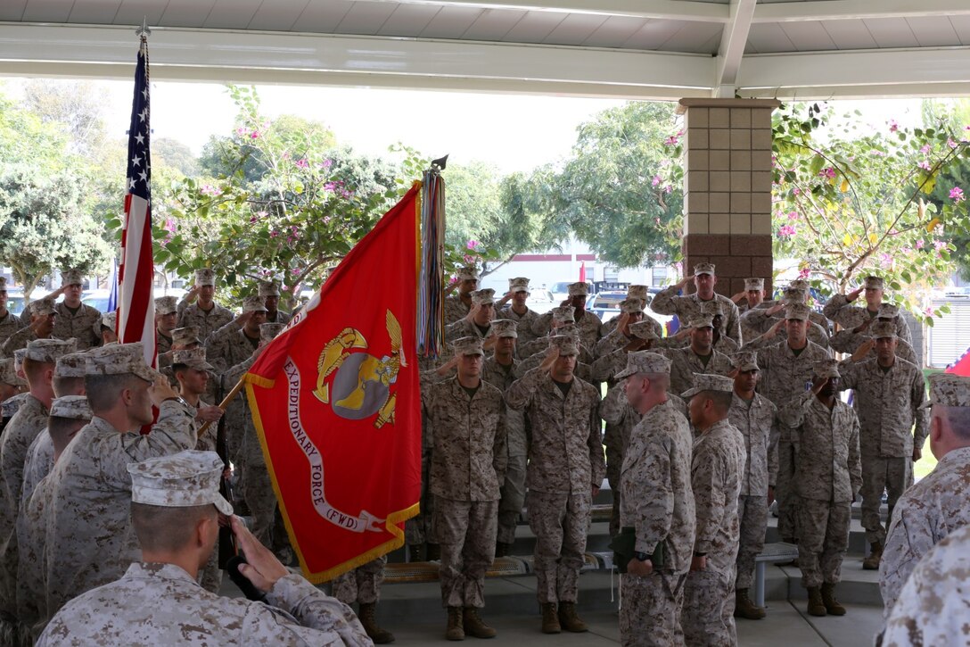 Brig. Gen. Daniel D. Yoo, commanding general, I Marine Expeditionary Force (Fwd), and Sgt. Maj. Douglas E. Berry, sergeant major, I MEF (Fwd), salute the colors as the national anthem plays during I MEF (Fwd)'s reactivation ceremony aboard Camp Pendleton, Calif., Oct. 23, 2013. During the ceremony, Brig. Gen. Yoo and Sgt. Maj. Berry officially uncased the unit's colors to symbolize the official reactivation of I MEF (Fwd).