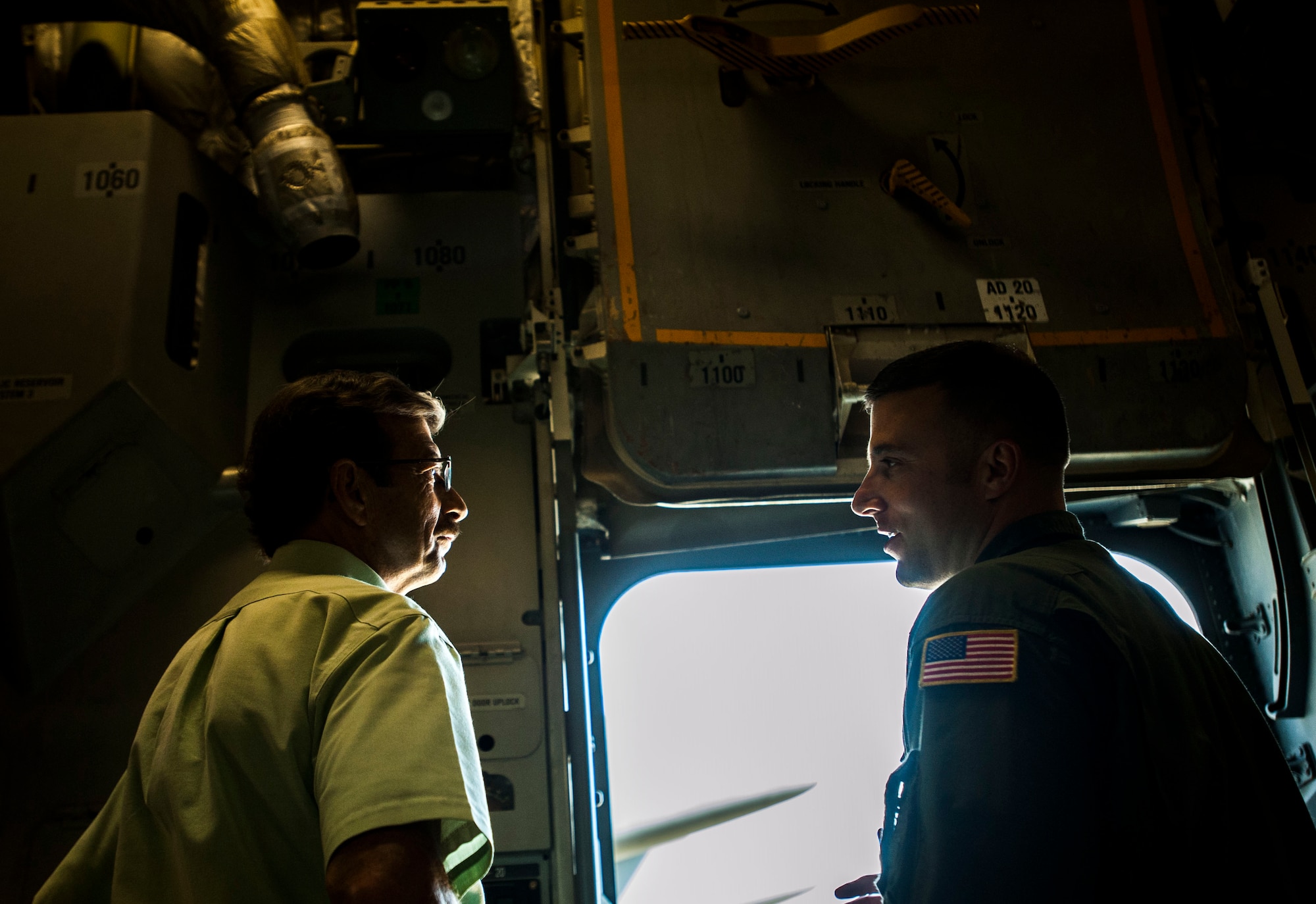 Tech. Sgt. Mike Morris, (right) 437th Airlift Wing Operations Group standards and evaluations loadmaster, explains to his father retired Chief Master Sgt. Bob Morris, C-17 Training Systems Charleston lead loadmaster, the modifications of the C-17 Globemaster III Sept. 17, 2013 at Joint Base Charleston, S.C. Bob is a retired loadmaster and was on the plane for the arrival of the first C-17 delivered to the Air Force in June 1993. 