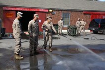 Pfc. Taren C. Seidel (right), a water support technician with 8th Engineer Support Battalion, 2nd Marine Logistics Group, and Lance Cpl. Michelle E. Rusz (right), an administration specialist with Combat Logistics Regiment 27, 2nd MLG, demonstrate the spray capabilities of the M26 Joint Service Transportable Decontamination System during a chemical, biological, radiological and nuclear decontamination course aboard Camp Lejeune, N.C., Oct. 23, 2013. The M26 was designed to be lightweight and have the ability to decontaminate personnel, equipment and vehicles from CBRN agents. 