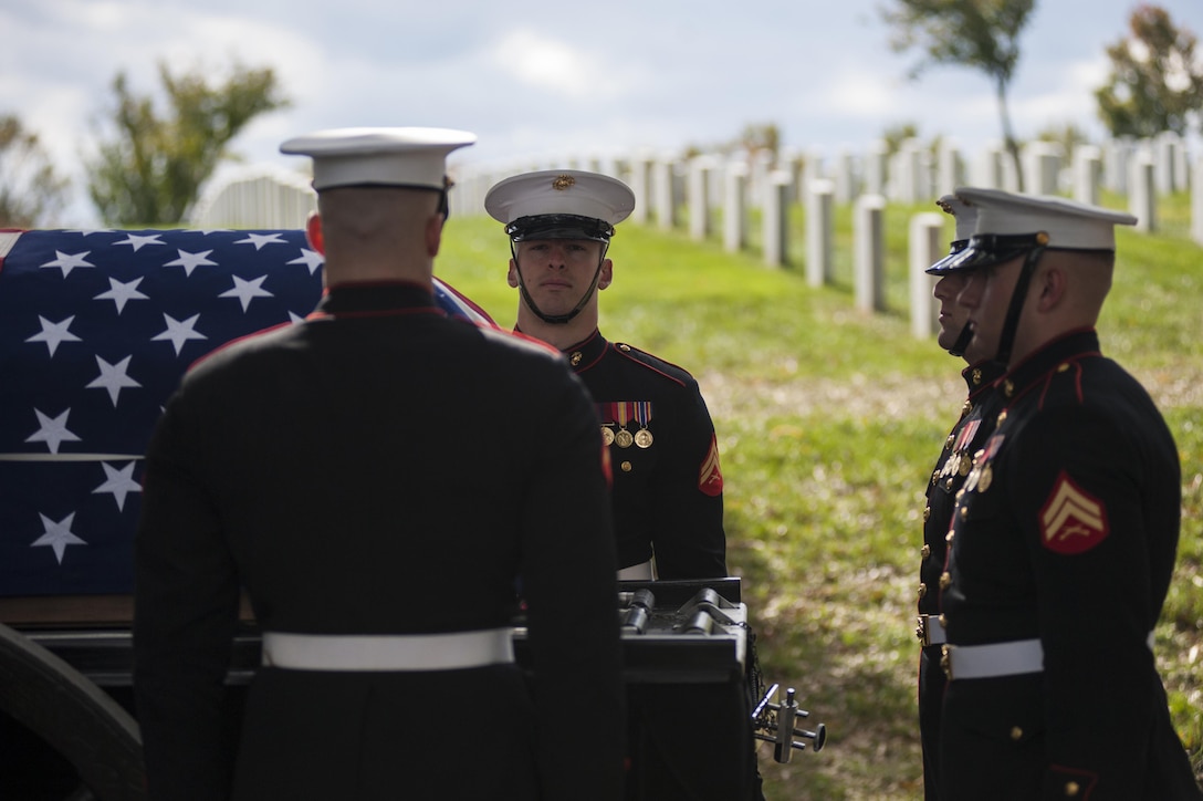 Body bearers with Marine Barracks Washington, D.C., stand at attention prior to removing the casket from a horse-drawn caisson during a funeral ceremony at Arlington National Cemetery Oct. 24. The ceremony, supported by the Barracks, was held for a group of six Marines who died in a CH-53 helicopter crash in Afghanistan on January 19, 2012. The deceased are Capt. Daniel Bartle, Capt. Nathan McHone, Master Sgt. Travis Riddick, Cpl. Jesse Stites, Cpl. Kevin Reinhard and Cpl. Joseph Logan.