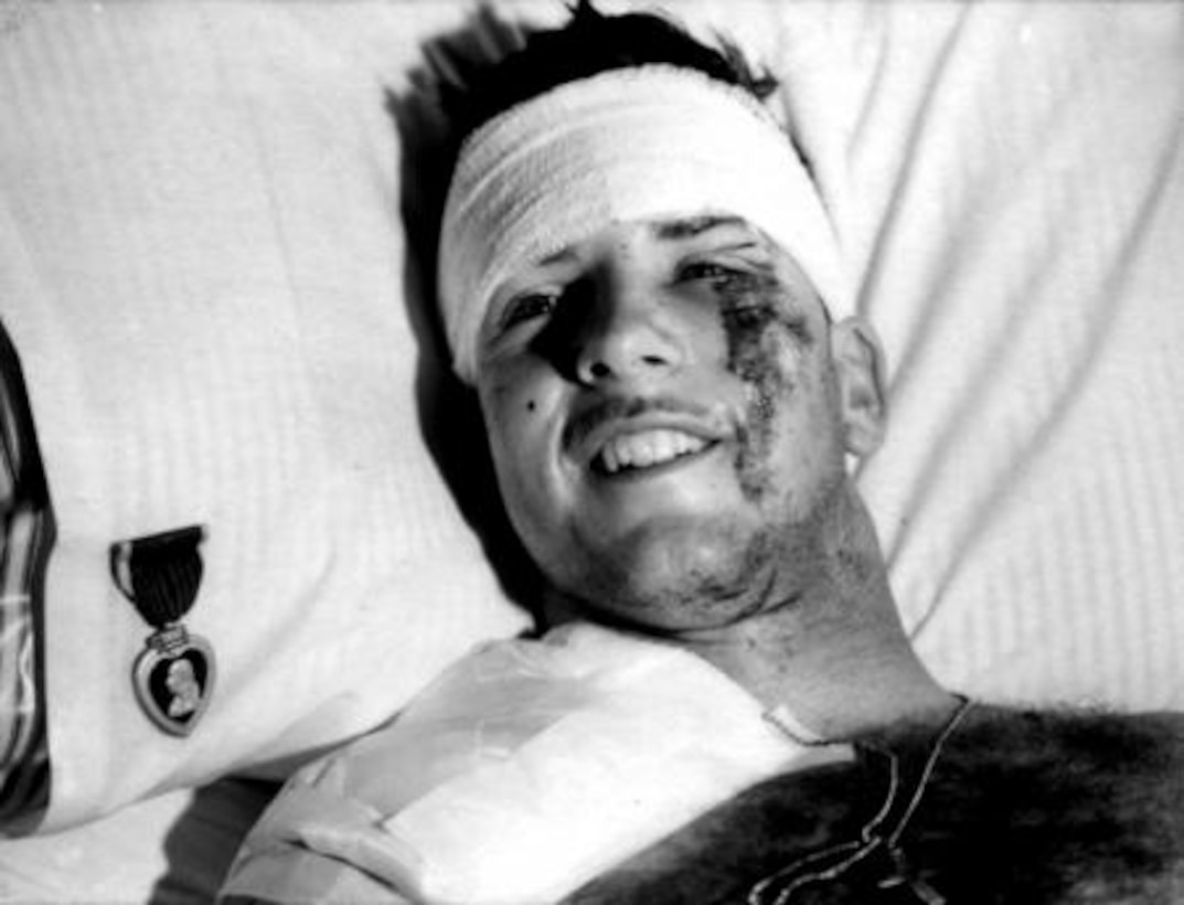 A Marine smiles in a hospital bed after receiving a Purple Heart from Gen. Paul X. Kelley. He survived the barracks bombing of Beirut on Oct. 23, 1983. This years marks the 30th anniversary.