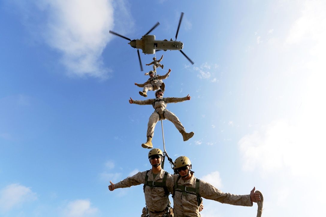 The Basic Reconnaissance Course class familiarizes themselves with Special Patrol Insertion/Extraction rigging southeast of Las Flores in an open field within the 41-area on Oct. 22. The training, also known as SPIE rigging, gives the students hands-on experience while hanging from the helicopter. “The biggest preparation for SPIE rigging was learning the knots, other than that it’s all practical application,” said HM2 Dustin Green, a student in the Basic Reconnaissance Course. The Marines will tie in on the ground and walk forward as the pilot gently takes off and lifts each student one by one until all are in the air. “It’s kind of unexplainable, you can’t really do anything besides stabilize while on the rope,” said Lance Cpl. Kyle Lopez, a student in the Basic Reconnaissance Course. 

The Basic Reconnaissance Course provides students with the basic knowledge of reconnaissance doctrine, concepts, and techniques with emphasis on amphibious entry, extraction, beach reconnaissance, Combat Rubber Reconnaissance Craft (CRRC) operator skills and ground reconnaissance patrolling skills.  The course combines lecture, demonstration, and practical application in communications, land navigation, supporting arms, rough terrain skills, patrolling information reporting, M18A1 claymore mine, nautical navigation, coxswain skills, scout swimmer techniques and physical training.