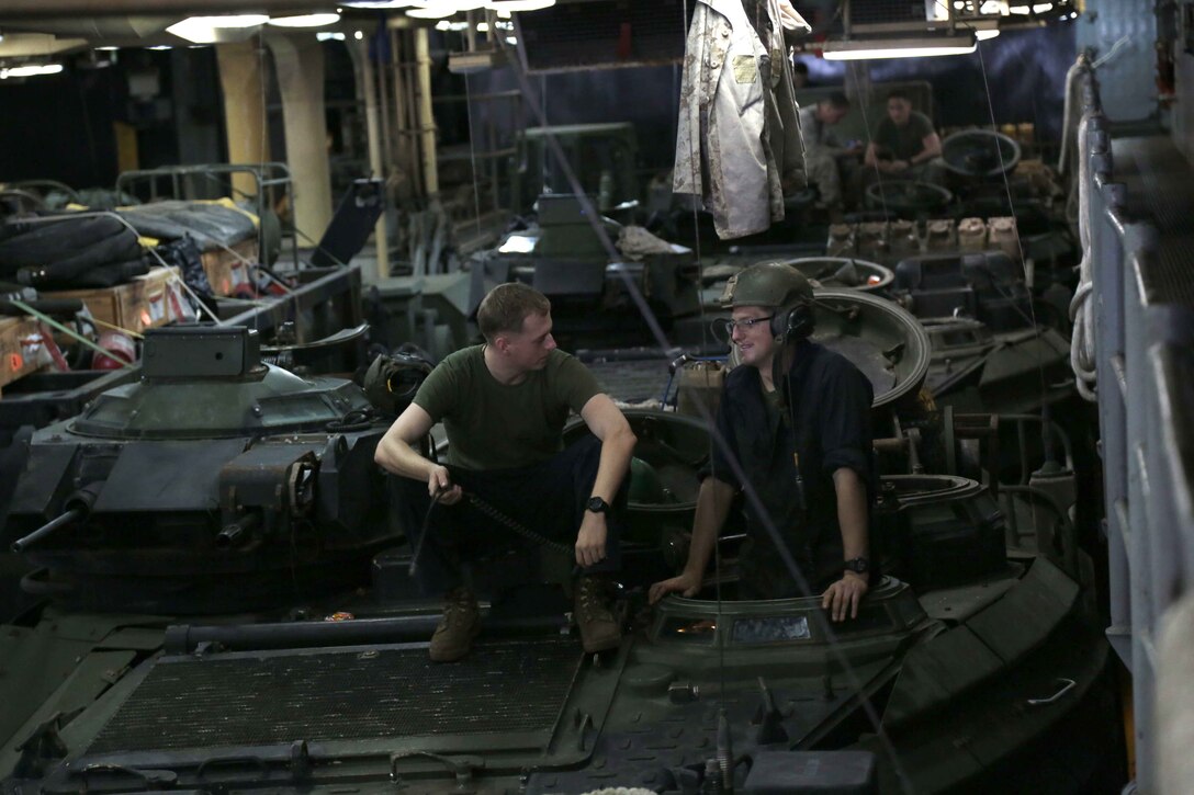 ARABIAN GULF (Oct. 17, 2013) Marines with Amphibious Assault Vehicle (AAV) Platoon, Bravo Company, Battalion Landing Team 1/4, 13th Marine Expeditionary Unit (MEU), perform pre-operation checks on their AAV's during preparation for debarking the amphibious dock landing ship USS Harpers Ferry (LSD 49), Oct. 17, 2013.  The 13th MEU is deployed with the Boxer Amphibious Ready Group as a theater reserve and crisis response force throughout the U.S. 5th Fleet area of responsibility.  (Official U.S. Marine Corps photo by Sgt. Christopher O'Quin/Released)
