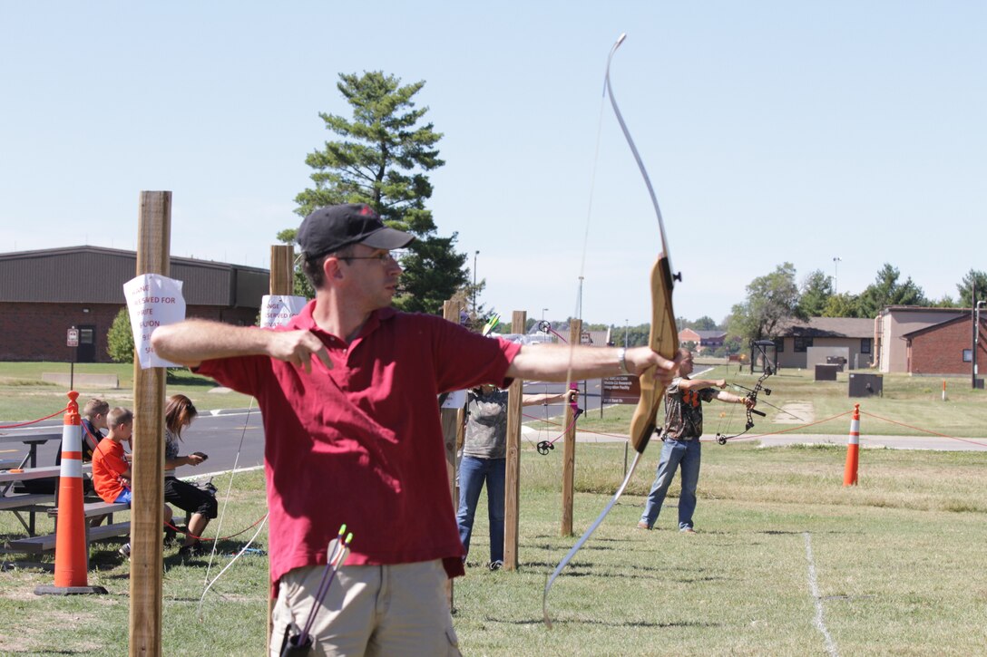 Capt. Michael Williams, 932nd Airlift Wing Protestant Chaplain, shows off his archery skills at the 3D Archery Shoot held during the 932nd AW annual family day. (Air Force photo by Staff Sgt. Meiko Schill.)