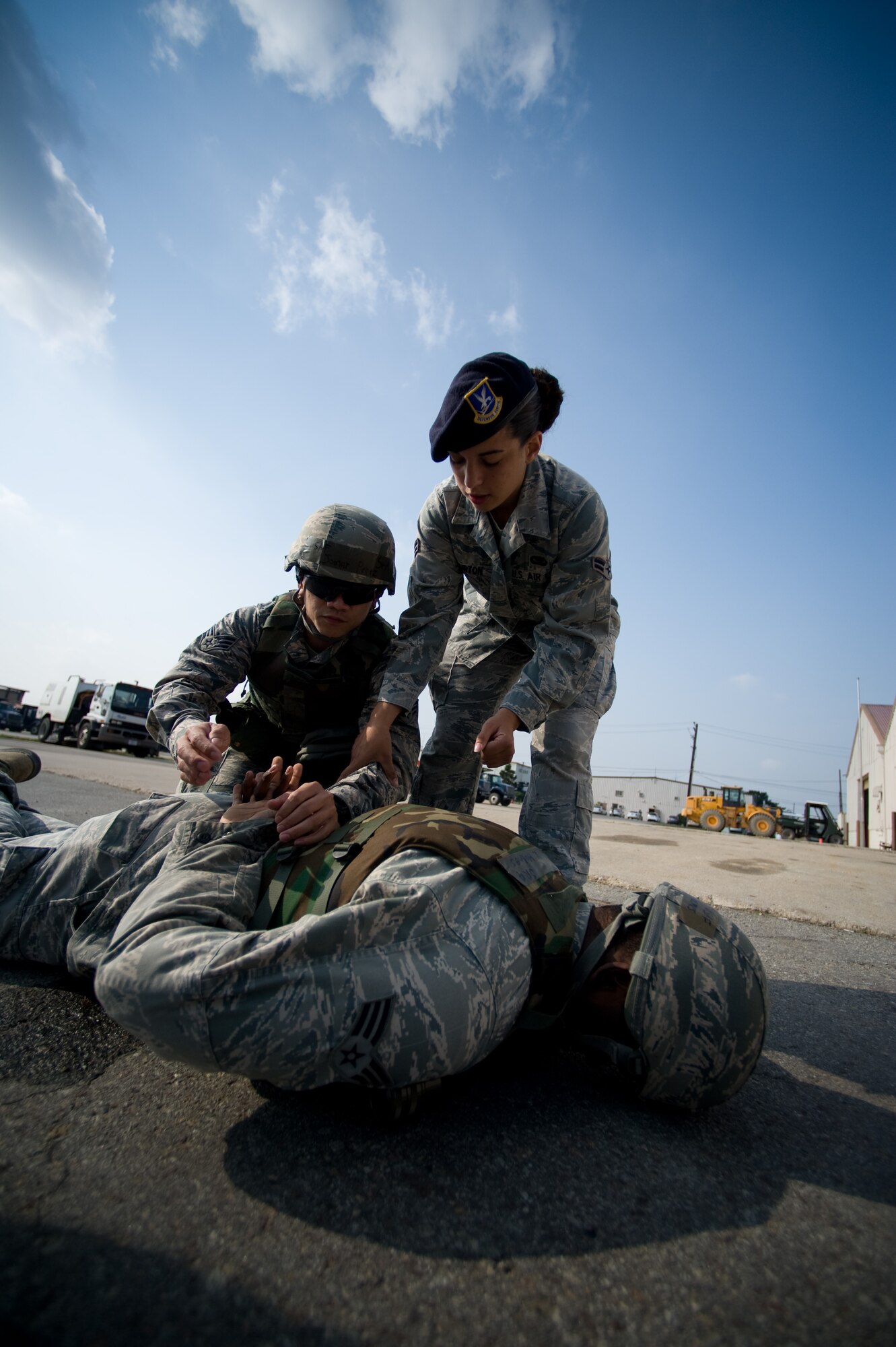 Airman 1st Class Kolina Burton, 8th Security Forces Squadron instructor, right, instructs Staff Sgt. Senior Jomar Perez, 8th Civil Engineer Squadron, on proper restraining techniques at Kunsan Air Base, Republic of Korea, Oct. 24, 2013. Airmen from the 8th CES trained with the 8th SFS on how to defend their compound. The 8th SFS trained the Red Devils on communication tactics, apprehending suspects and manning defensive positions. (U.S. Air Force photo by Senior Airman Armando A. Schwier-Morales/Released)