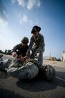 Airman 1st Class Kolina Burton, 8th Security Forces Squadron instructor, right, instructs Staff Sgt. Senior Jomar Perez, 8th Civil Engineer Squadron, on proper restraining techniques at Kunsan Air Base, Republic of Korea, Oct. 24, 2013. Airmen from the 8th CES trained with the 8th SFS on how to defend their compound. The 8th SFS trained the Red Devils on communication tactics, apprehending suspects and manning defensive positions. (U.S. Air Force photo by Senior Airman Armando A. Schwier-Morales/Released)
