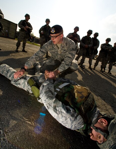 Airman 1st Class Zane Muller, 8th Security Forces Squadron instructor, demonstrates how to search and approach someone at Kunsan Air Base, Republic of Korea, Oct. 24, 2013. Airmen from the 8th CES trained with the 8th SFS on how to defend their compound. The 8th SFS trained the Red Devils on communication tactics, apprehending suspects and manning defensive positions. (U.S. Air Force photo by Senior Airman Armando A. Schwier-Morales/Released)