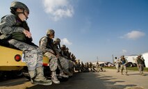 Airmen from the 8th Civil Engineer Squadron Red Devils listen to a security forces squadron instructor at Kunsan Air Base, Republic of Korea, Oct. 24, 2013. Airmen from the 8th CES trained with the 8th Security Forces Squadron on how to defend their compound. The 8th SFS trained the Red Devils on communication tactics, apprehending suspects and manning defensive positions. (U.S. Air Force photo by Senior Airman Armando A. Schwier-Morales/Released)