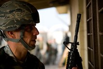 Lt. Col. Frank Hughes, 8th Civil Engineer Squadron commander, receives his weapon during the 8th CES readiness training day at Kunsan Air Base, Republic of Korea, Oct. 24, 2103. Airmen from the 8th CES trained with the 8th Security Forces Squadron on how to defend their compound. The 8th SFS trained the Red Devils on communication tactics, apprehending suspects and manning defensive positions. (U.S. Air Force photo by Senior Airman Armando A. Schwier-Morales/Released)