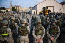 Lt. Col. Frank Hughes, 8th Civil Engineer Squadron commander, middle, speaks to his squadron before the beginning of the squadron’s readiness training day at Kunsan Air Base, Republic of Korea, Oct. 24, 2013. Airmen from the 8th CES trained with the 8th Security Forces Squadron on how to defend their compound. The 8th SFS trained the Red Devils on communication tactics, apprehending suspects and manning defensive positions. (U.S. Air Force photo by Senior Airman Armando A. Schwier-Morales/Released)