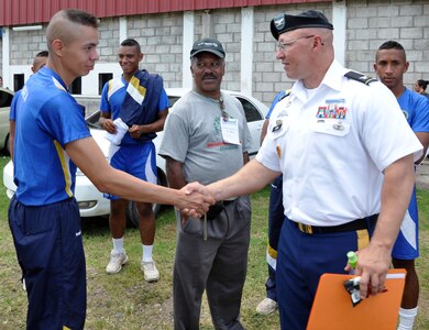 Col. John Sena, commander, Army Support Activity, visits with a cadet from the Honduran Air Force academy following the Opening Ceremony for the Honduran Special Olympics at Carlos Miranda Stadium, Comayagua, Honduras, Oct. 24, 2013.  Cadets from the academy carried the Special Olympic torch on a run from Soto Cano Air Base to Comayagua.  Joint Task Force-Bravo is providing support for the Honduras Special Olympics soccer tournament, which will be played at Soto Cano Air Base.  (U.S. Air Force photo by Capt. Zach Anderson)