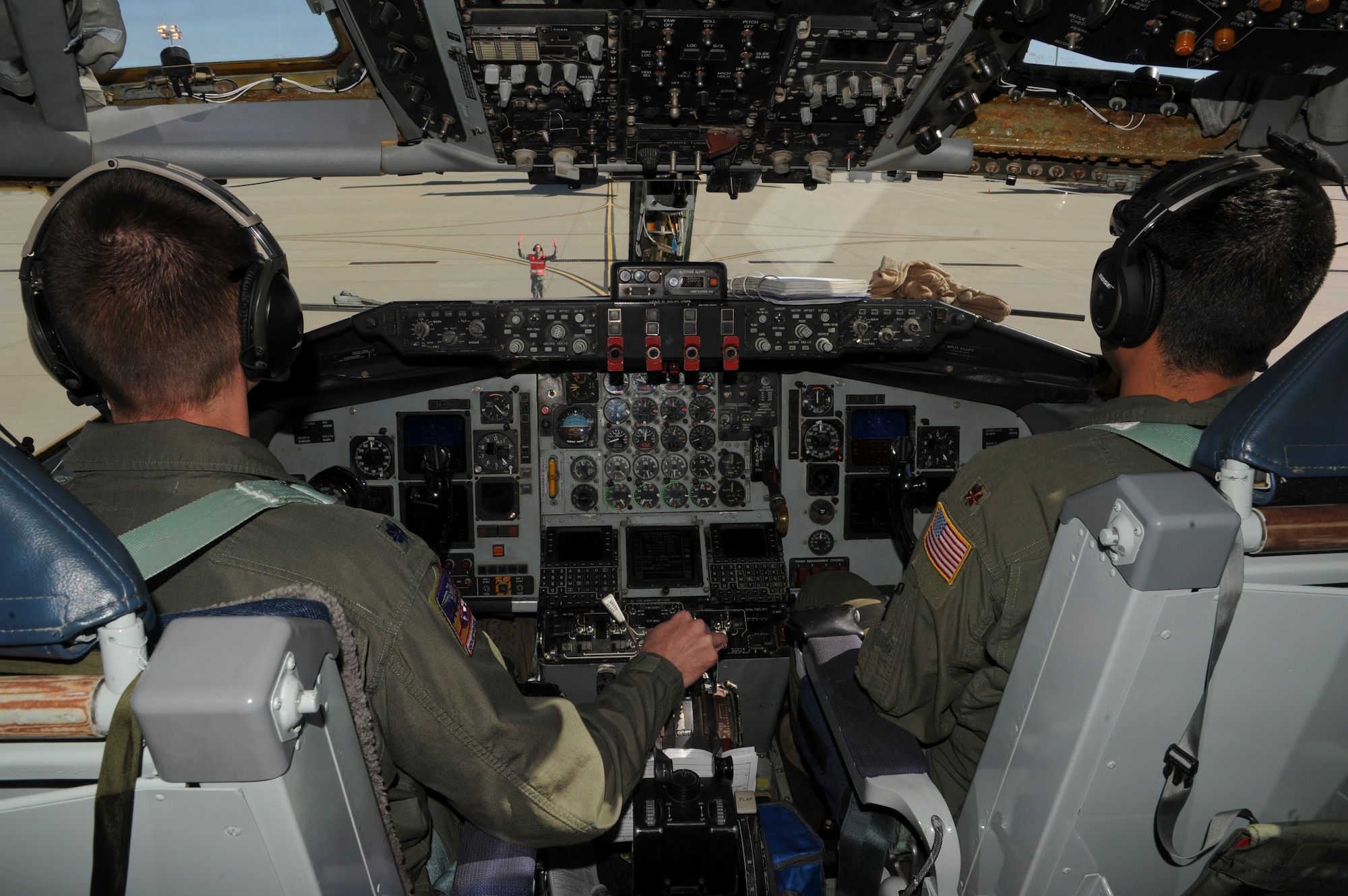 Pilots from the 384th Air Refueling Squadron are marshaled into position onto a ramp Oct. 23, 2013, at McConnell Air Force Base Kan., following a training mission. Training missions are executed regularly to enhance the global reach of flying units for real-world missions. (U.S. Air Force photo/Airman 1st Class John Linzmeier)