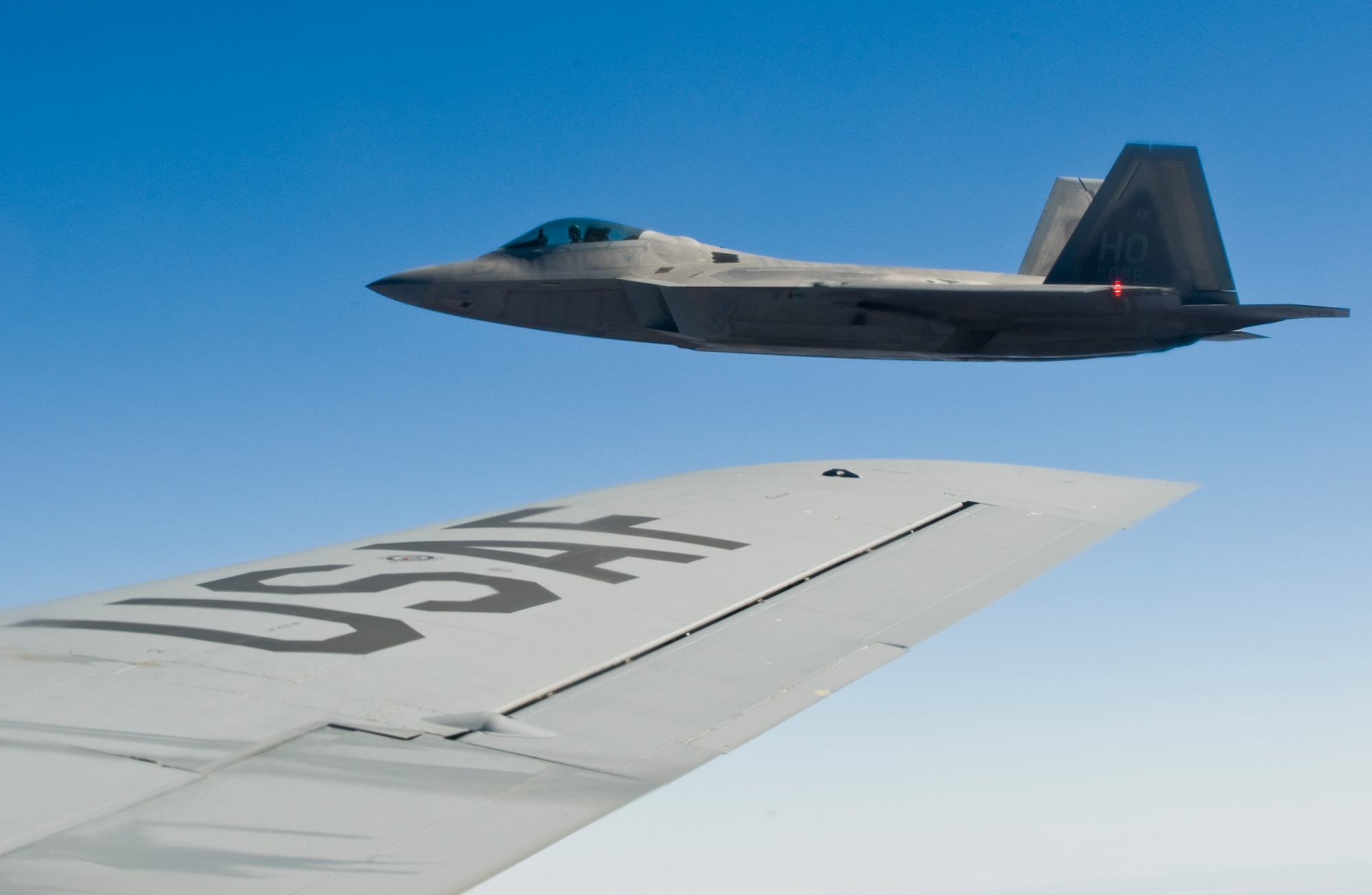 An F-22 Raptor assigned to the 49th Fighter Wing, Holloman Air Force Base, N.M., flies next to a KC-135 Stratotanker from McConnell Air Force Base, Kan., Oct. 23, 2013. Training missions are executed regularly to enhance the global reach of flying units for real-world missions. (U.S. Air Force photo/Airman 1st Class John Linzmeier)