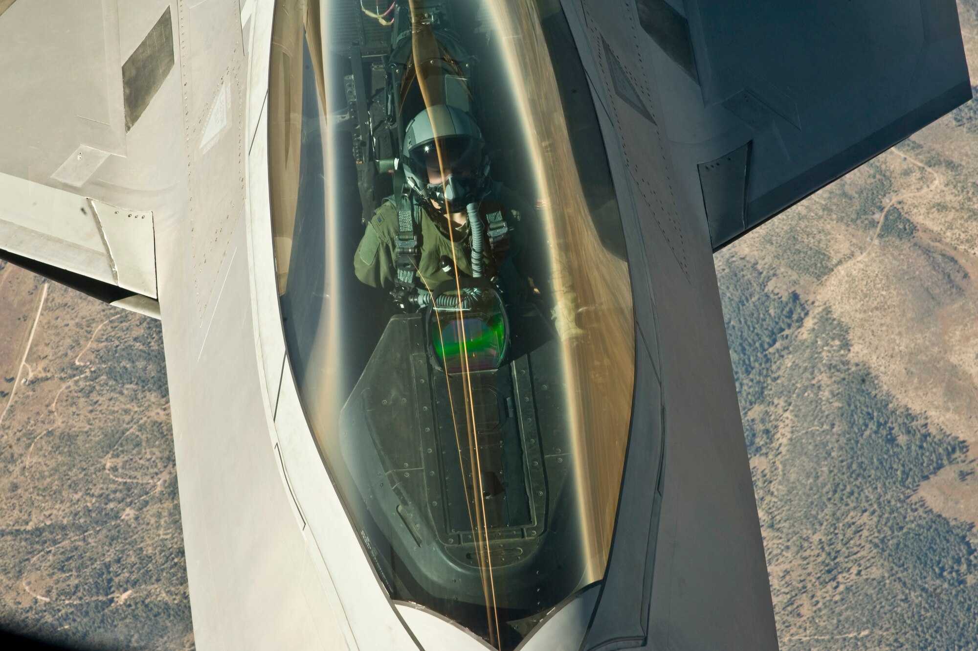 A fighter pilot from the 49th Fighter Wing, at Holloman Air Force Base, N.M., prepares to refuel an F-22 Raptor from behind a KC-135 Stratotanker from McConnell Air Force Base, Kan., Oct. 23, 2013. The F-22 is a highly advanced fifth-generation fighter plane. (U.S. Air Force photo/Airman 1st Class John Linzmeier)
