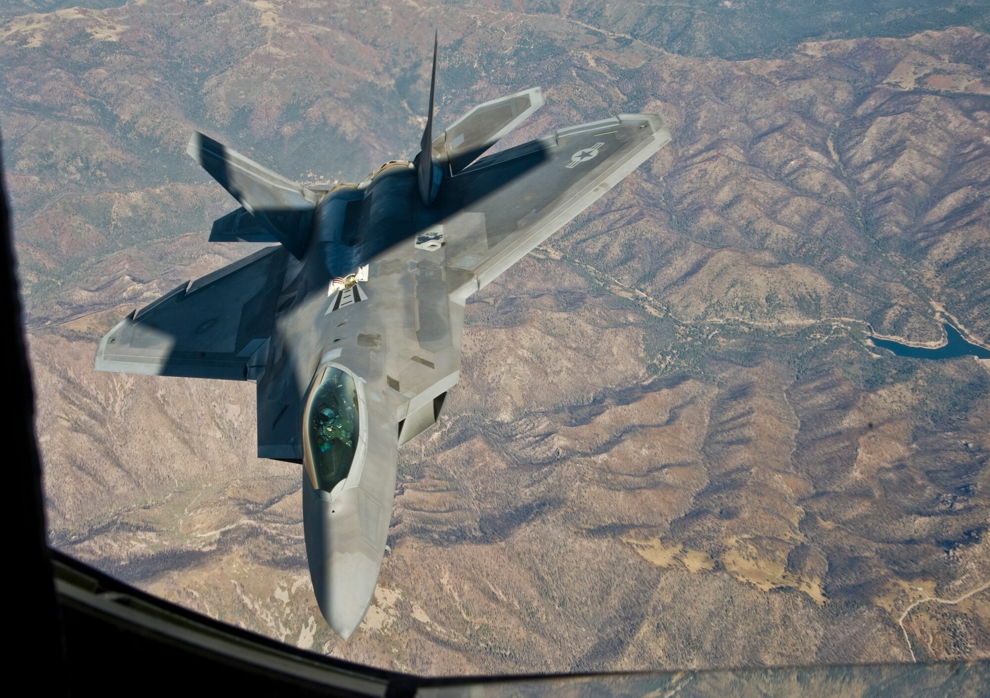 An F-22 Raptor assigned to the 49th Fighter Wing, at Holloman Air Force Base, N.M., banks right after receiving fuel from a KC-135 Stratotanker from McConnell Air Force Base, Kan., Oct. 23, 2013. F-22s are a critical component of the Global Strike Task Force and are designed to project air dominance at great distances. (U.S. Air Force photo/Airman 1st Class John Linzmeier)