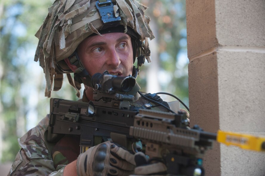 Royal Air Force Lance Cpl. Michael Gold, No. 1 Squadron RAF Regiment, searches for suspected terrorists in the military operations in urban terrain (MOUT) village during Exercise GLOBAL EAGLE at Moody Air Force Base, Ga., Oct. 17, 2013. Exercise GLOBAL EAGLE is a joint-military exercise held every year to improve the working relationship between the two countries. (U.S. Air Force photo by Airman Dillian Bamman/Released)