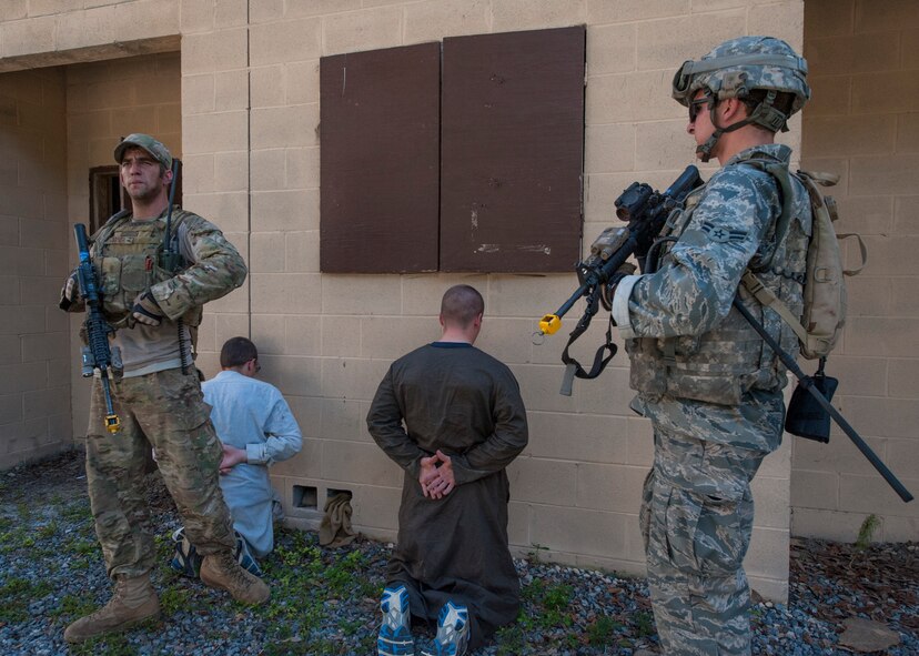 Airmen from 822d Base Defense Squadron hold villagers for interrogation during Exercise GLOBAL EAGLE at Moody Air Force Base, Ga., Oct. 17, 2013. The 822d BDS hosted Exercise GLOBAL EAGLE to confirm and strengthen combat readiness. (U.S. Air Force photo by Airman Dillian Bamman/Released)