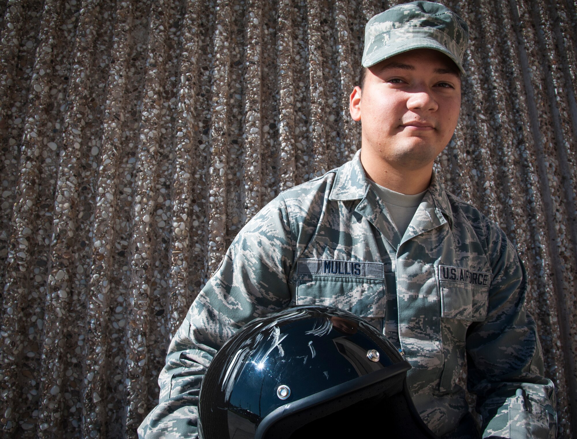 Airman 1st Class Randy Mullis, 47th Operations Support Squadron radar approach control operator, poses with the helmet that saved his life at Laughlin Air Force Base, Texas, Oct. 23, 2013. Recently, Mullis was thrown from his bike during an accident, landing head-first into a boulder near the road. According to the doctors that tended to Mullis, he would not have survived the crash if he was not wearing his helmet that day. (U.S. Air Force photo/Senior Airman John D. Partlow)