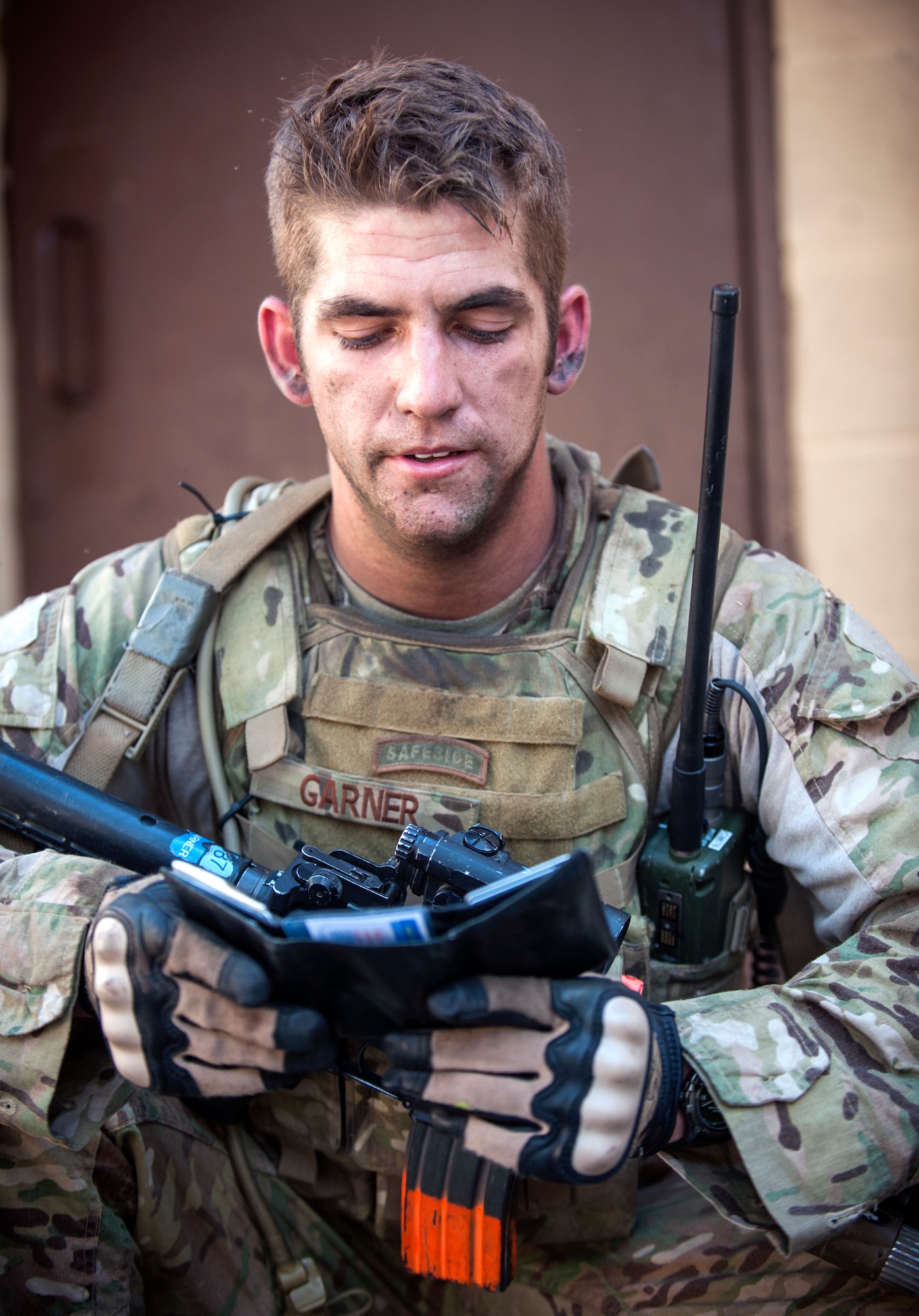 U.S. Air Force Senior Airman Richard Garner, 822d Base Defense Squadron, checks a villager’s ID cards during Exercise GLOBAL EAGLE at Moody Air Force Base, Ga., Oct. 17, 2013. Garner and his teammates were investigating the man after they were attacked in the village. (U.S. Air Force photo by Senior Airman Jarrod Grammel/Released)
