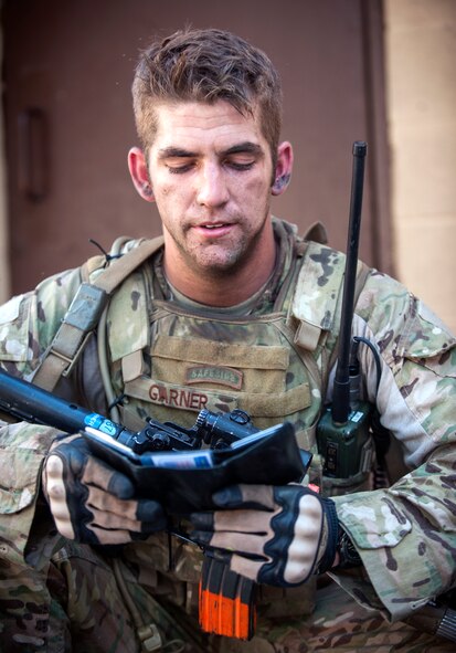 U.S. Air Force Senior Airman Richard Garner, 822d Base Defense Squadron, checks a villager’s ID cards during Exercise GLOBAL EAGLE at Moody Air Force Base, Ga., Oct. 17, 2013. Garner and his teammates were investigating the man after they were attacked in the village. (U.S. Air Force photo by Senior Airman Jarrod Grammel/Released)
