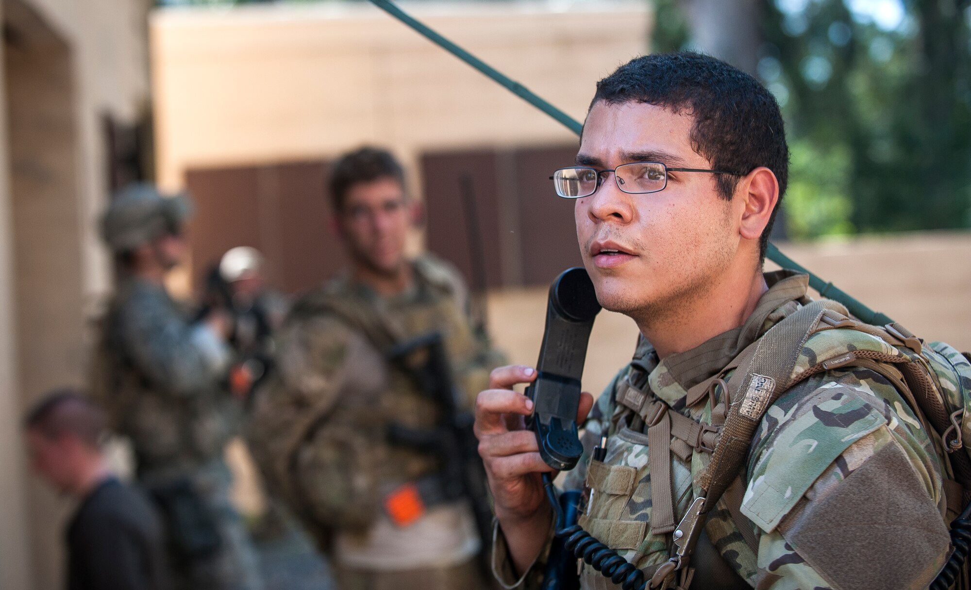 U.S. Air Force Senior Airman Sean Soria, 822d Base Defense Squadron, confirms details with a teammate before making a radio call during Exercise GLOBAL EAGLE at Moody Air Force Base, Ga., Oct. 17, 2013. Approximately 40 Royal Air Force Regiment members visited Moody for the two-week exercise. (U.S. Air Force photo by Senior Airman Jarrod Grammel/Released)

