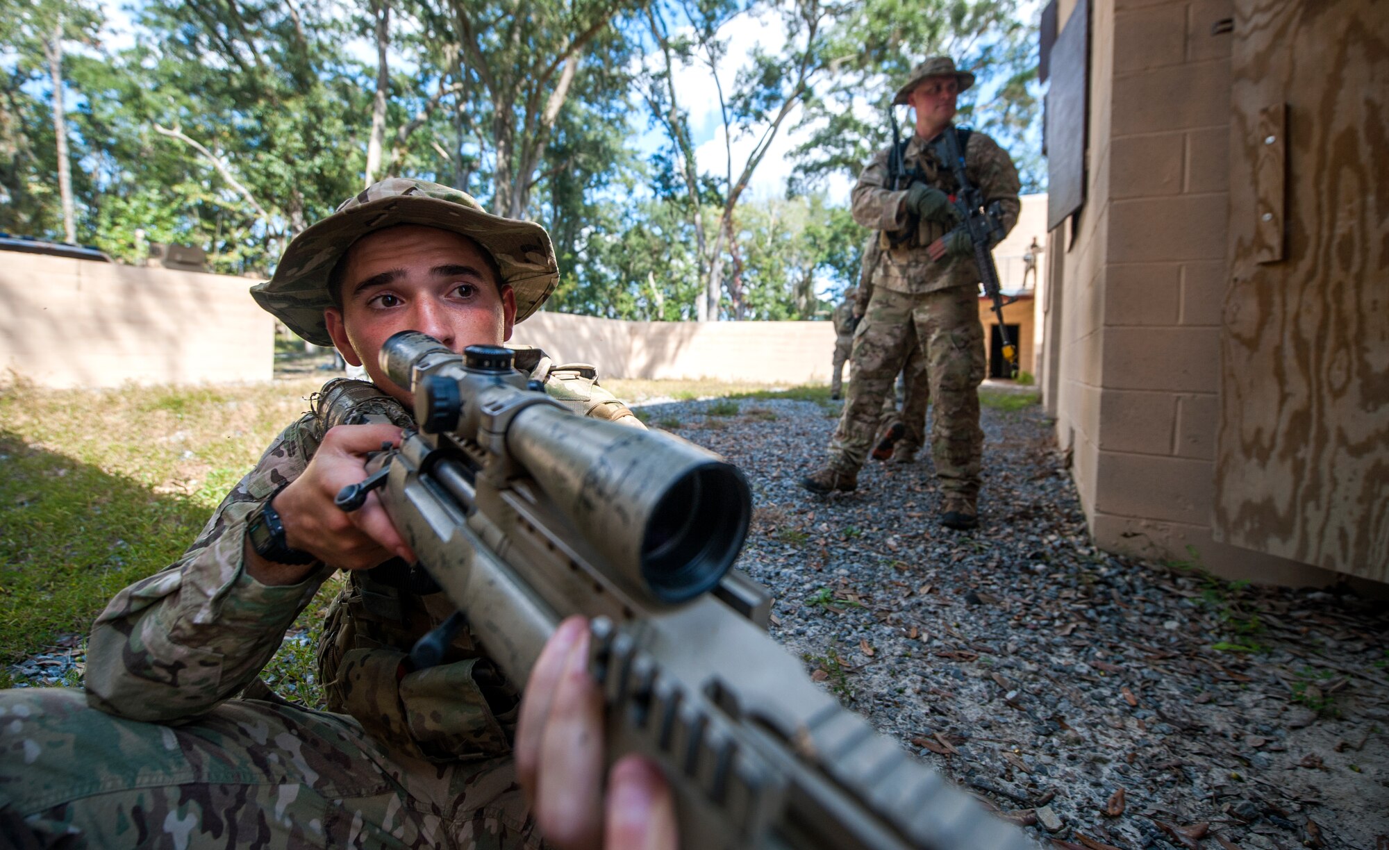 U.S. Air Force Senior Airman William Scott, 822d Base Defense Squadron designated marksman, keeps a lookout at the military operations in urban terrain (MOUT) village during Exercise GLOBAL EAGLE at Moody Air Force Base, Ga., Oct. 17, 2013. In 2012, the 824th Base Defense Squadron traveled to Stanford Training Area, England, to train with No. 15 Squadron, Royal Air Force Regiment. (U.S. Air Force photo by Senior Airman Jarrod Grammel/Released)
