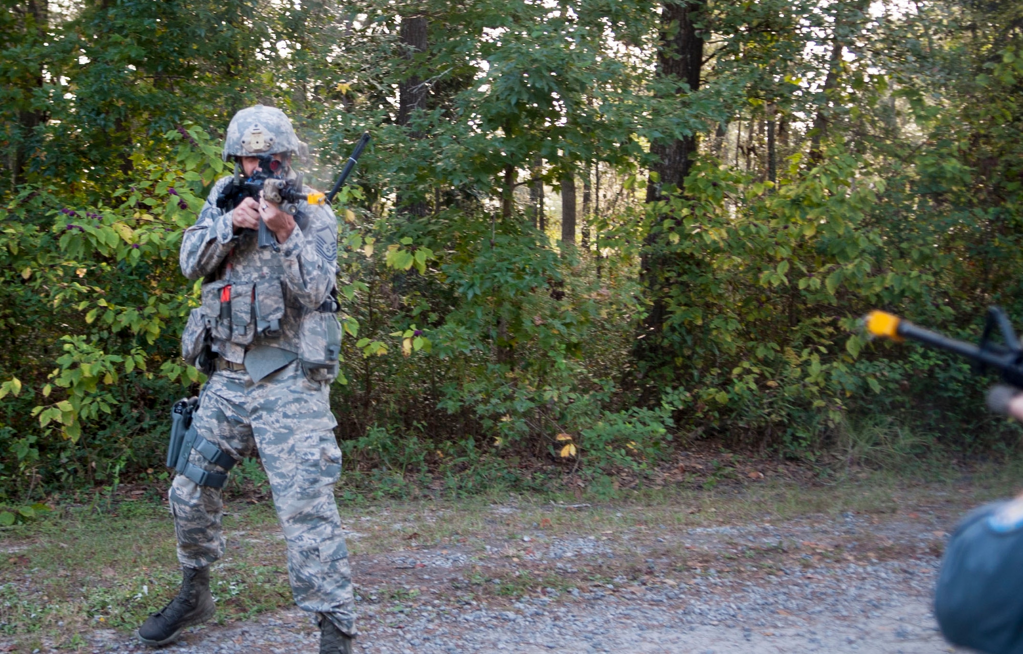 U.S. Air Force Master Sgt. Christopher Souza, 822d Base Defense Squadron squad leader, returns fire in a simulated confrontation during the GLOBAL EAGLE Exercise at Moody Air Force Base, Ga., Oct. 13, 2013. The Base Defense Group and  Royal Air Force Regiment alternate between England and the U.S. for the annual exercise.  (U.S. Air Force photo by Airman 1st Class Sandra Marrero/Released)
