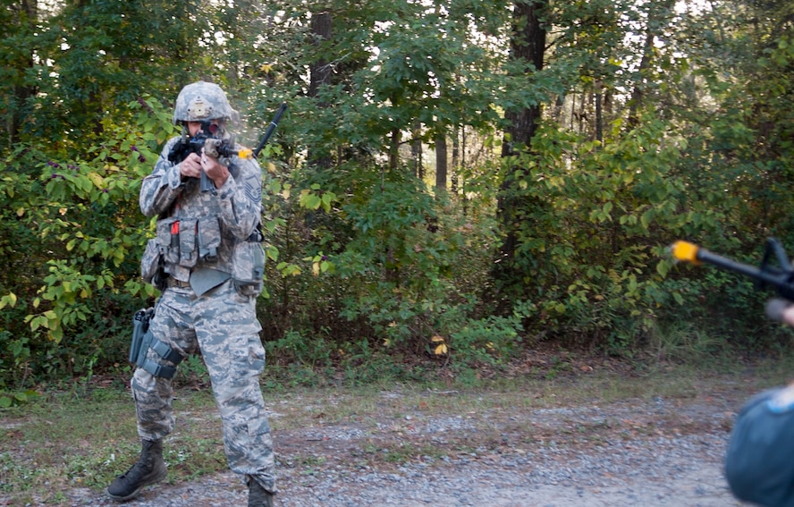 U.S. Air Force Master Sgt. Christopher Souza, 822d Base Defense Squadron squad leader, returns fire in a simulated confrontation during the GLOBAL EAGLE Exercise at Moody Air Force Base, Ga., Oct. 13, 2013. The Base Defense Group and  Royal Air Force Regiment alternate between England and the U.S. for the annual exercise.  (U.S. Air Force photo by Airman 1st Class Sandra Marrero/Released)
