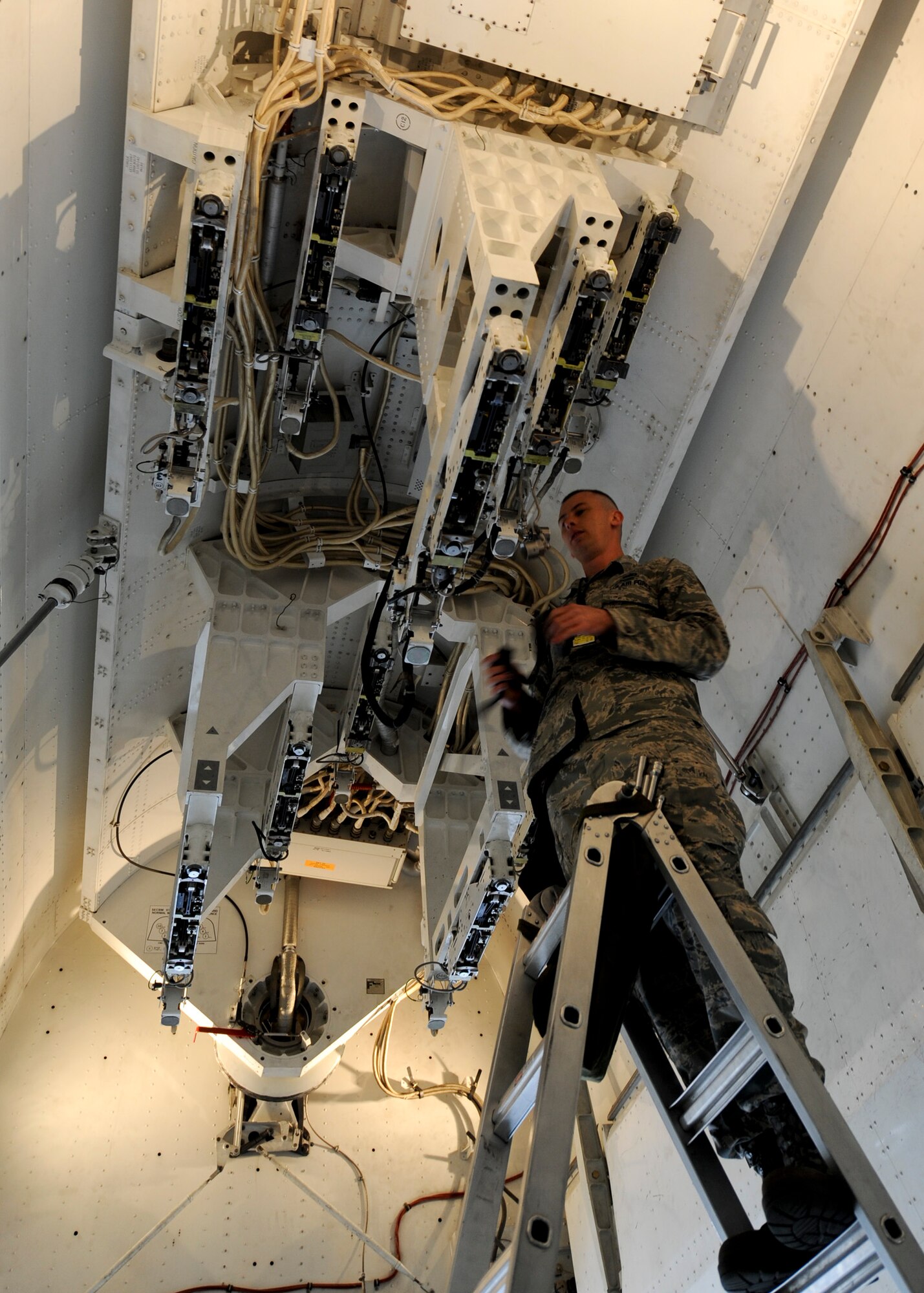 Staff Sgt. Andrew Peppin, 34th Aircraft Maintenance Unit weapons load crew member, prepares a bomb bay for loading during the third quarter load crew competition at Ellsworth Air Force Base, S.D., Oct. 18, 2013. The competition featured two, four-person teams from the 34th and 37th Bomb Squadrons who were rated on their time and efficiency while properly loading munitions according to established standards. (U.S. Air Force photo by Senior Airman Anania Tekurio/Released)