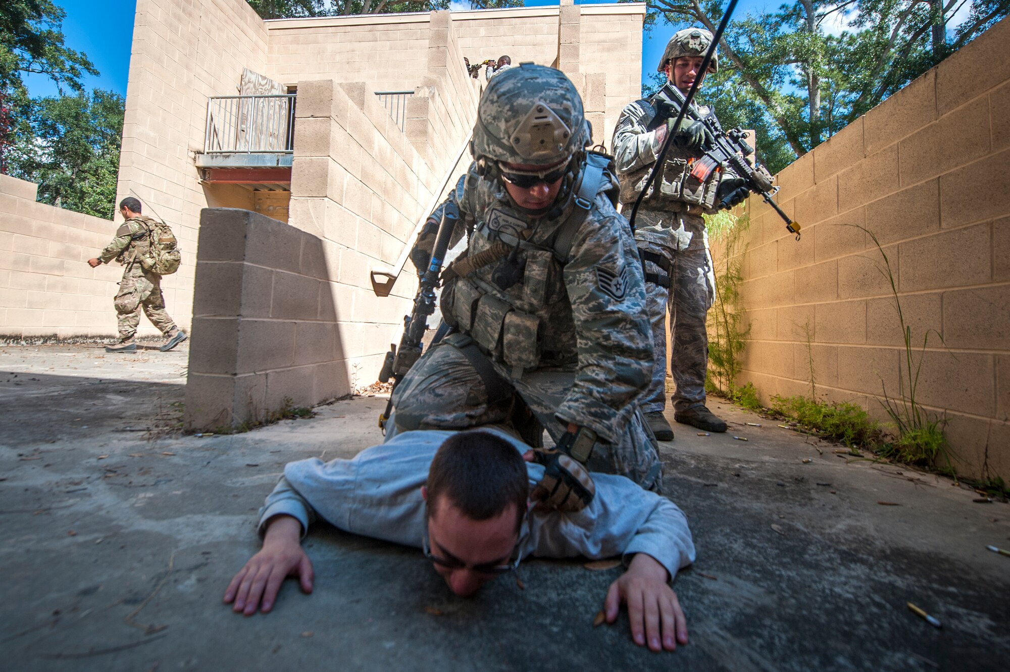 U.S. Air Force Staff Sgt. Pablo Cancel, 822d Base Defense Squadron, apprehends a suspect during Exercise GLOBAL EAGLE at Moody Air Force Base, Ga., Oct. 17, 2013. For the scenario, participants had to recognize and observe villagers moving a suspicious package and respond accordingly. (U.S. Air Force photo by Senior Airman Jarrod Grammel/Released)
