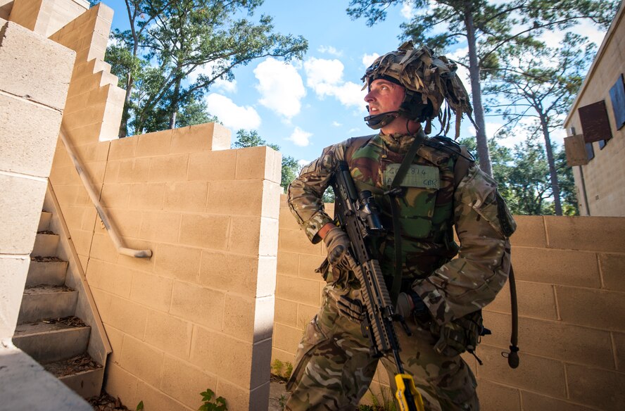 Royal Air Force Lance Cpl. Michael Gold, No. 1 Squadron RAF Regiment, communicates with his teammates during Exercise GLOBAL EAGLE at Moody Air Force Base, Ga., Oct. 17, 2013. Every year, RAF Regiment and 820th Base Defense Group defenders train together to exchange tactics, techniques and procedures. (U.S. Air Force photo by Senior Airman Jarrod Grammel/Released)
