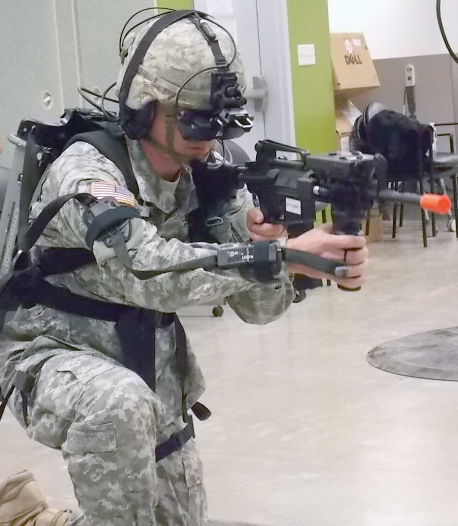 A National Guardsman from 1-141 Infantry Battalion, located at Joint Base San Antonio-Camp Bullis, takes up a fighting position during a scenario in the virtual training environment. (Army Photo Courtesy of HHC, Southern Training Division 75th Training Command)