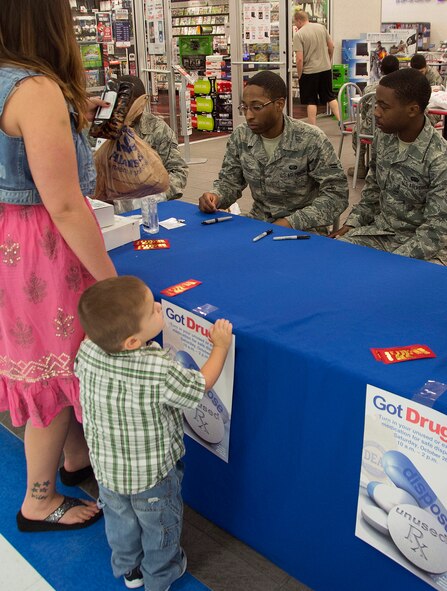 A Team Barksdale member turns in expired medication to Airmen during Drug Take-Back Day on Barksdale Air Force Base, La., Oct. 23, 2013. The bi-annual event is held to allow Team Barksdale members to turn in expired, unused and unwanted prescription drugs for destruction. More than 180 pounds of prescriptions were turned in last year and disposed of by the 2nd Security Forces Squadron and Drug Enforcement Agency. (U.S. Air Force photo/Staff Sgt. Amber Corcoran)