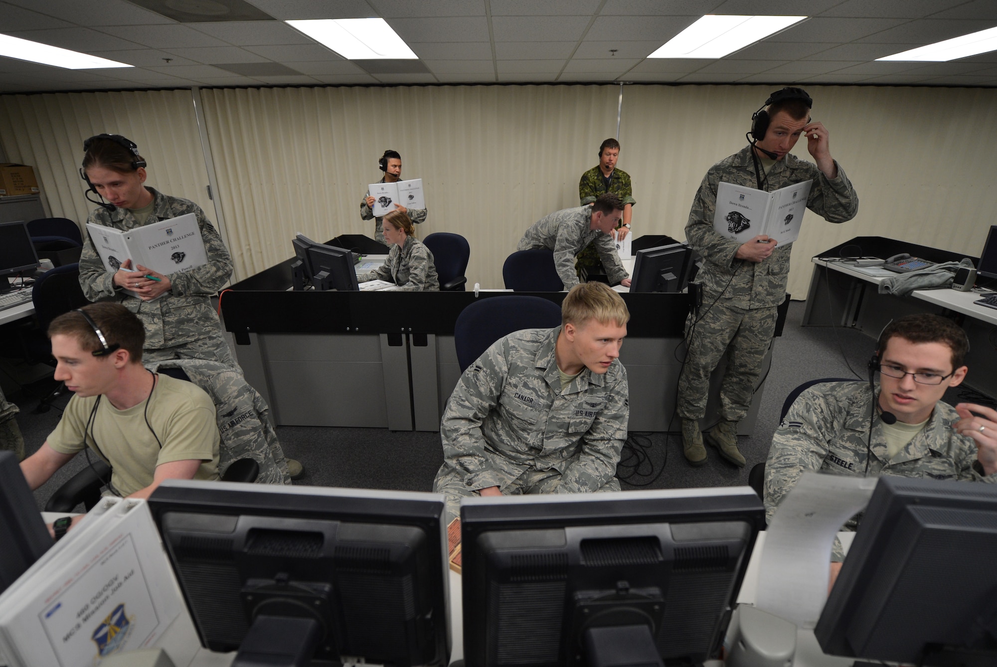 Members of the 2nd Space Warning Squadron carry out the operational performance portion of the Panther Challenge Oct. 10, 2013, at a training suite on Buckley Air Force Base, Colo. The 460th Space Wing hosted the first-ever Panther Challenge, a competition testing operational performance and crew knowledge, throughout October. (U.S. Air Force photo by Airman 1st Class Riley Johnson/Released)