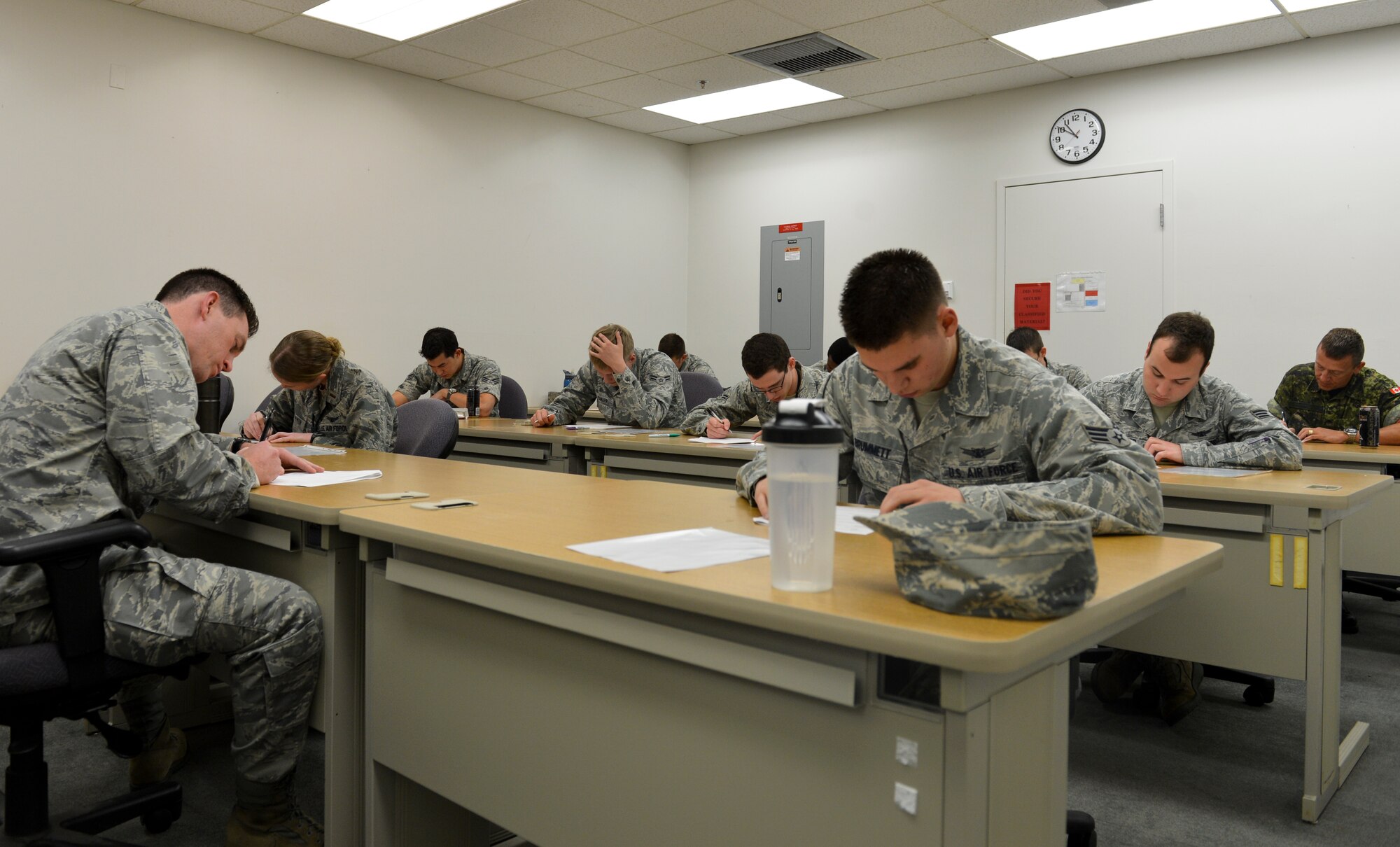 Members of the 2nd Space Warning Squadron execute the written test portion of the Panther Challenge Oct. 10, 2013, at a training suite on Buckley Air Force Base, Colo. The 460th Space Wing hosted the first-ever Panther Challenge, a competition testing operational performance and crew knowledge, throughout October. (U.S. Air Force photo by Airman 1st Class Riley Johnson/Released)