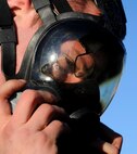 Senior Airman Lyndon Courtney, 5th Aircraft Maintenance Squadron crew cheif, adjusts his respirator mask at Minot Air Force Base, N.D., Oct. 16. Sturdefant works long hours to complete his part of the critical mission of the B-52 at MinotAFB. (U.S. Air Force photo/Airman 1st Class Andrew Crawford)