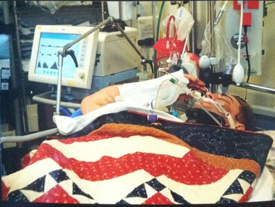 Army Cpl. Joshua Hargis, with the 3rd Ranger Battalion, salutes his commander during a Purple Heart presentation in Afghanistan. (Army Photo Courtesy of Brooke Army Medical Center Public Affairs)