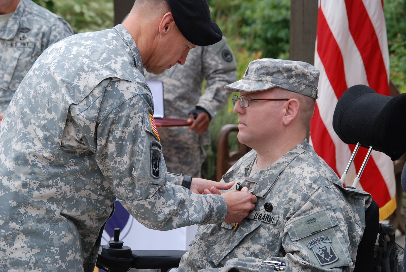 Staff Sgt. Edward Matayka receives a Purple Heart from Maj. Gen. William Roy, deputy commanding general for Operations U.S. Army North (Fifth Army), during an Oct. 18 ceremony at the Warrior and Family Support Center. Matayka, a combat medic, was injured in Afghanistan when his vehicle was struck by a roadside bomb. (Army Photo by Robert Shields, Brooke Army Medical Center Public Affairs)