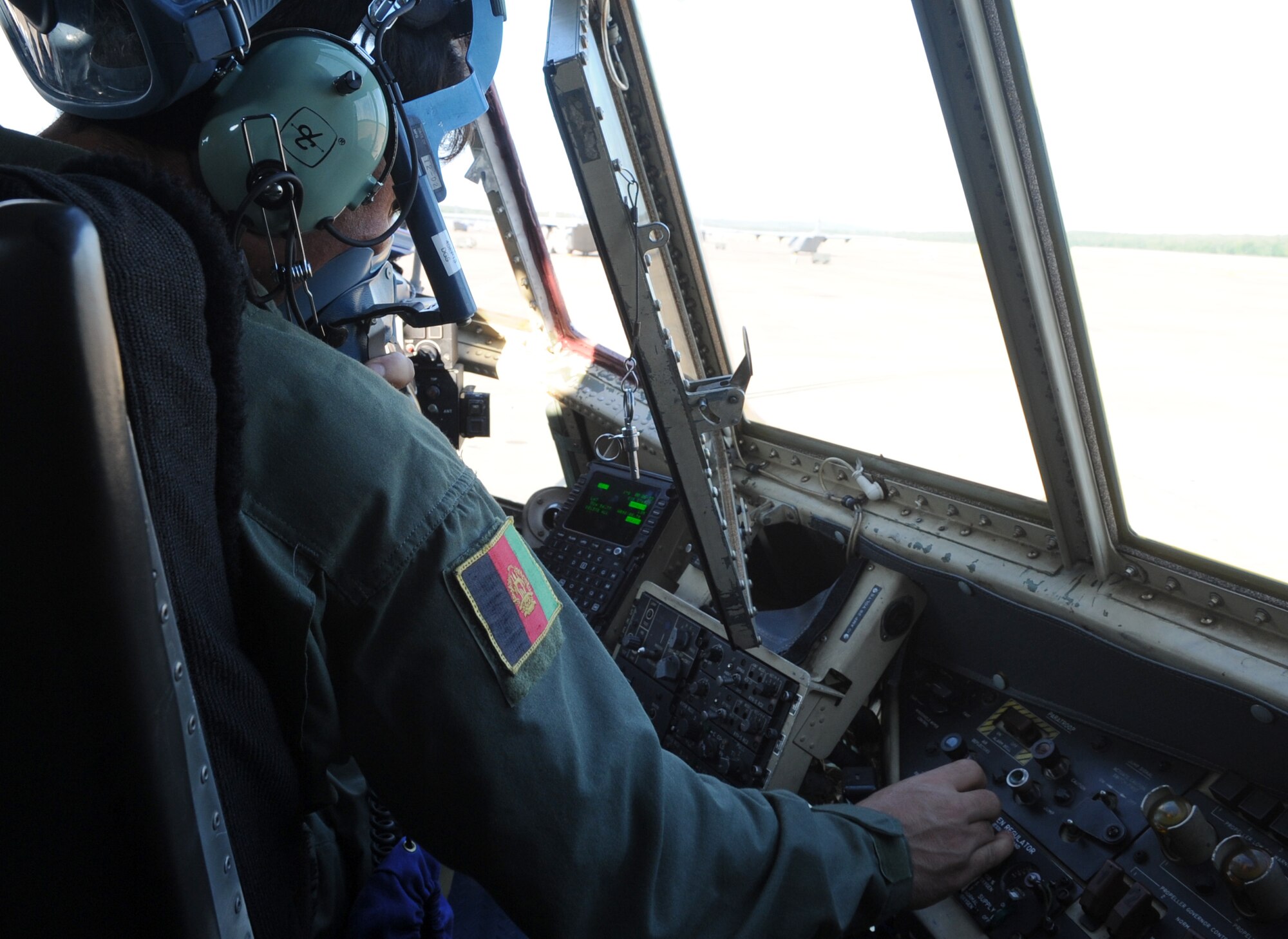 Afghanistan Air Force pilot, Lt. Khial Shinwari, checks his breathing apparatus before his first flight in a C-130H during training with the 62nd Airlift Squadron Sept. 3, 2013, at Little Rock Air Force Base, Ark.  Lt. Col. Aimal Sayedi Pacha and Shinwari accomplished rigorous academics, simulators and several qualifying flights to complete the 5-month program with the 314th Airlift Wing. (U.S. Air Force photo by Staff Sgt. Caleb Pierce) 
