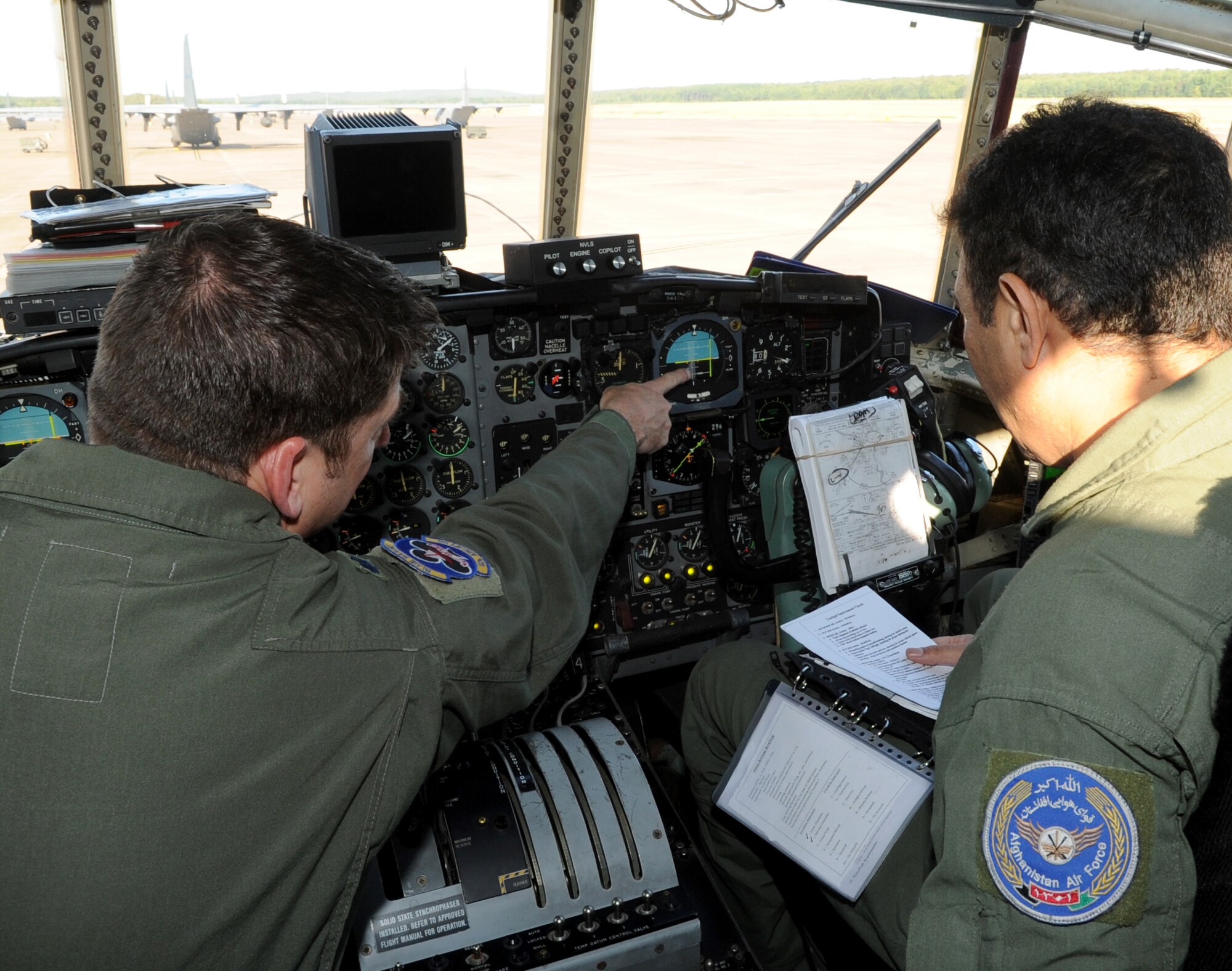 Afghanistan Air Force pilot, Lt. Khial Shinwari, checks his breathing apparatus before his first flight in a C-130H during training with the 62nd Airlift Squadron Sept. 3, 2013, at Little Rock Air Force Base, Ark.  Lt. Col. Aimal Sayedi Pacha and Shinwari accomplished rigorous academics, simulators and several qualifying flights to complete the 5-month program with the 314th Airlift Wing. (U.S. Air Force photo by Staff Sgt. Caleb Pierce) 
