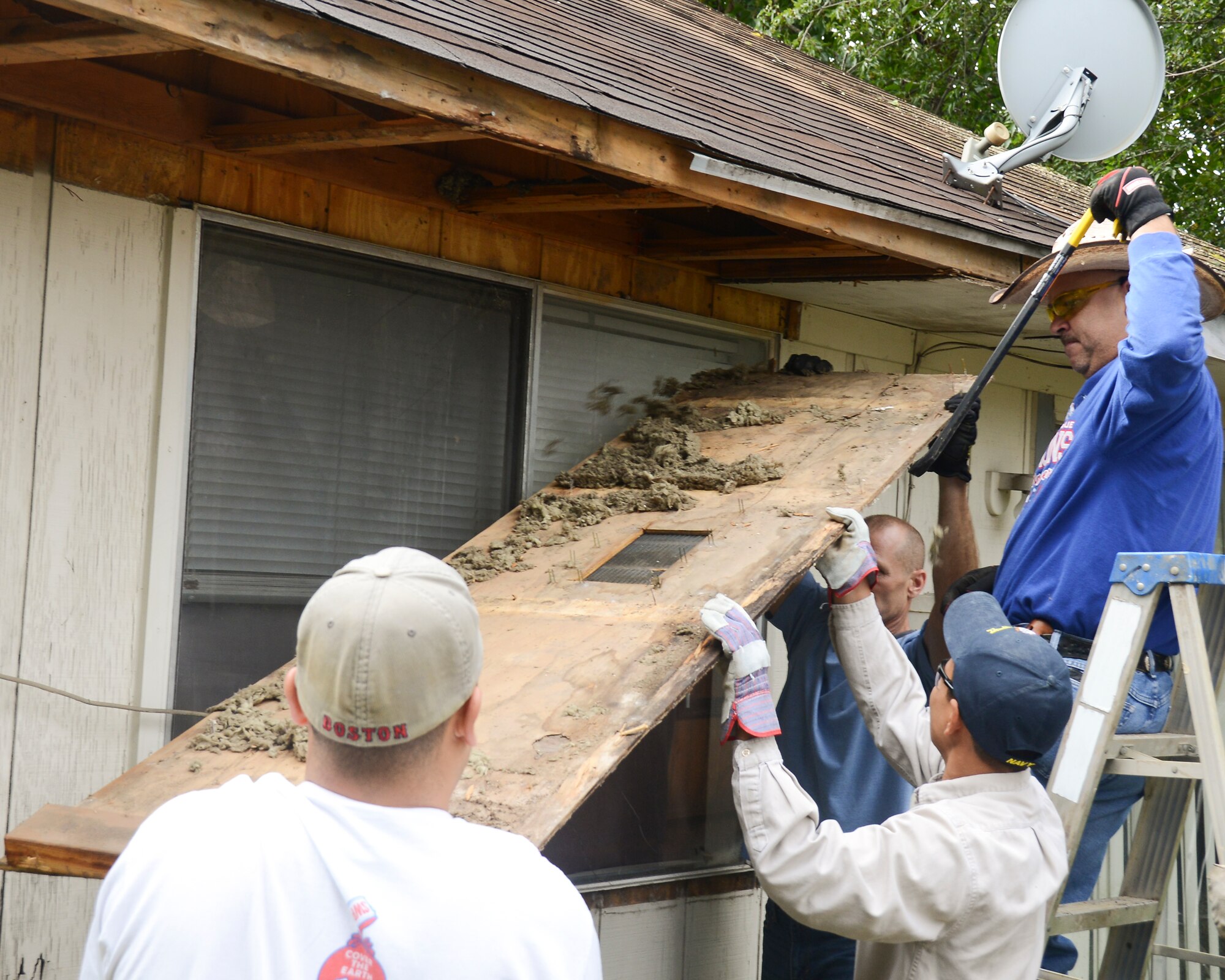 Members of the 147th Reconnaissance Wing remove dry-rotted wood from a Vietnam veteran's home during a Rebuilding Together Houston project. Rebuilding Houston Together is a non-profit charity that helps low income disabled elderly people get emergency critical repairs done to their homes. National Guard photo by Master Sgt. Sean Cowher