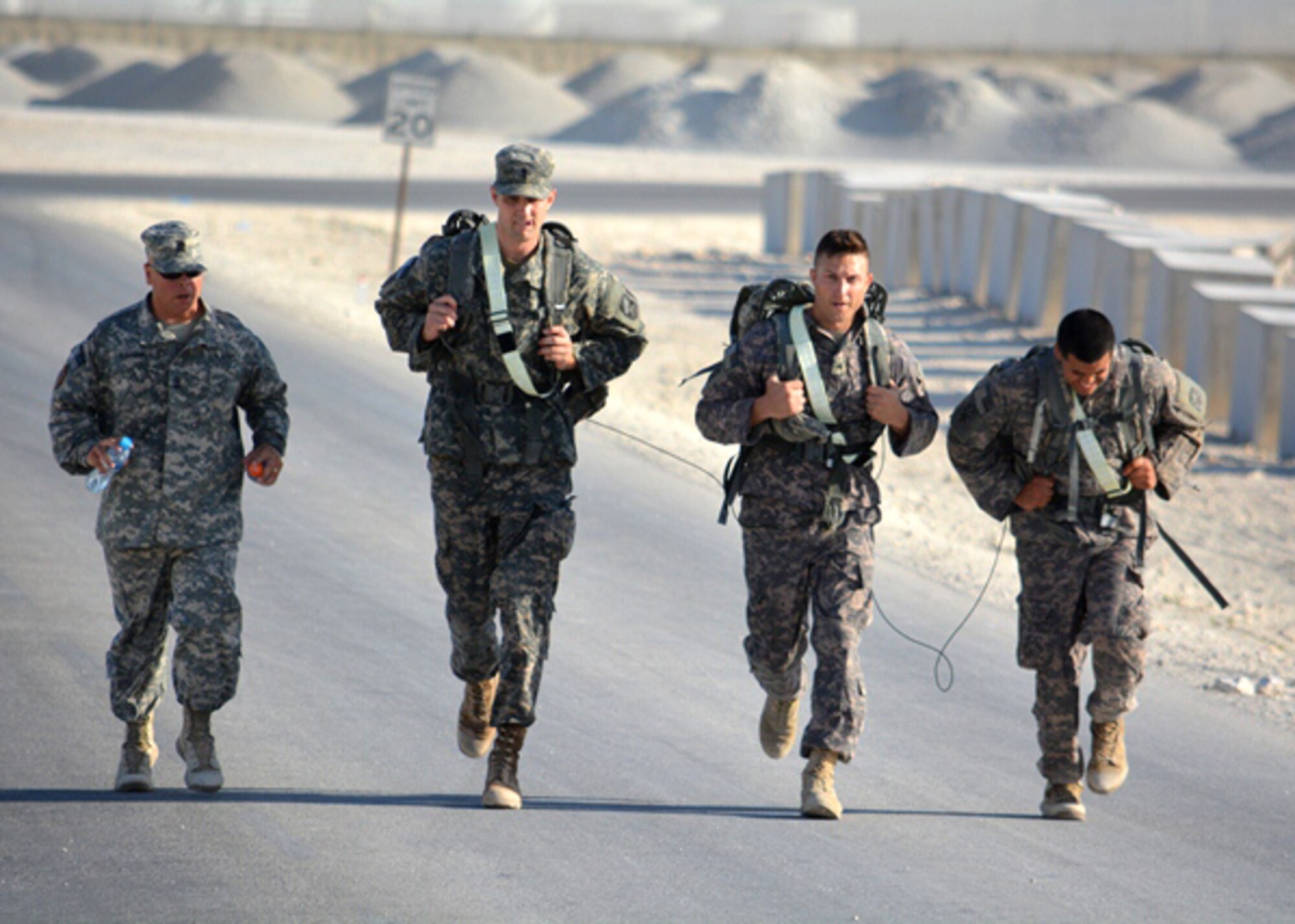 1st Sgt. Donald Marshall pushes a team to a strong finish during a Best Cobra Competition, a grueling four-day competition hosted by Headquarters and Headquarters Battery, 1-43 ADA at Isa Air Base, Bahrain. The 143rd ADA is known throughout the Central Command Area or Responsibility as Task Force Cobra, and falls under the command of the 31st ADA Brigade in Southwest Asia. (U.S. Army photo/1st. Lt. Jose Torres)