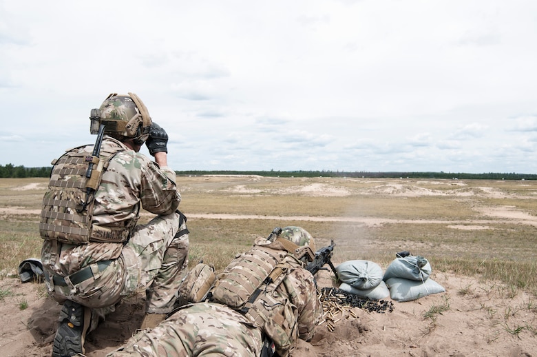 Members of the 113th Air Support Operations Squadron deployed in support of  Northern Strike August 13, 2013.  A portion of the training accomplished during Northern Strike was qualification on numerous weapons systems to include the M240B, M249, M2, MK-19, and M320. (LtoR): 1st Lt. Edward Shulman acts as a spotter for Master Sgt. Damon Girton as he qualifies with the M240B, 7.62mm Crew Served Weapon.
