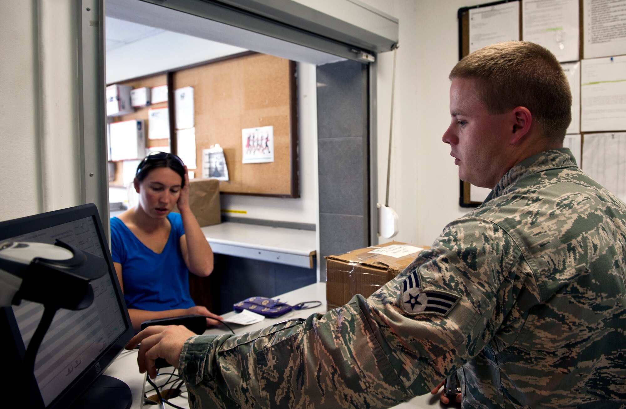 Senior Airman Jonathan Dalrymple, 39th Communications Squadron official documents center clerk, prepares a package for Kristin Ryan Oct. 24, 2013, at Incirlik Air Base, Turkey. The holidays are coming up and customers need to be sure to get their gifts out in time for the season. (U.S. Air Force photo by Senior Airman Daniel Phelps/Released) 