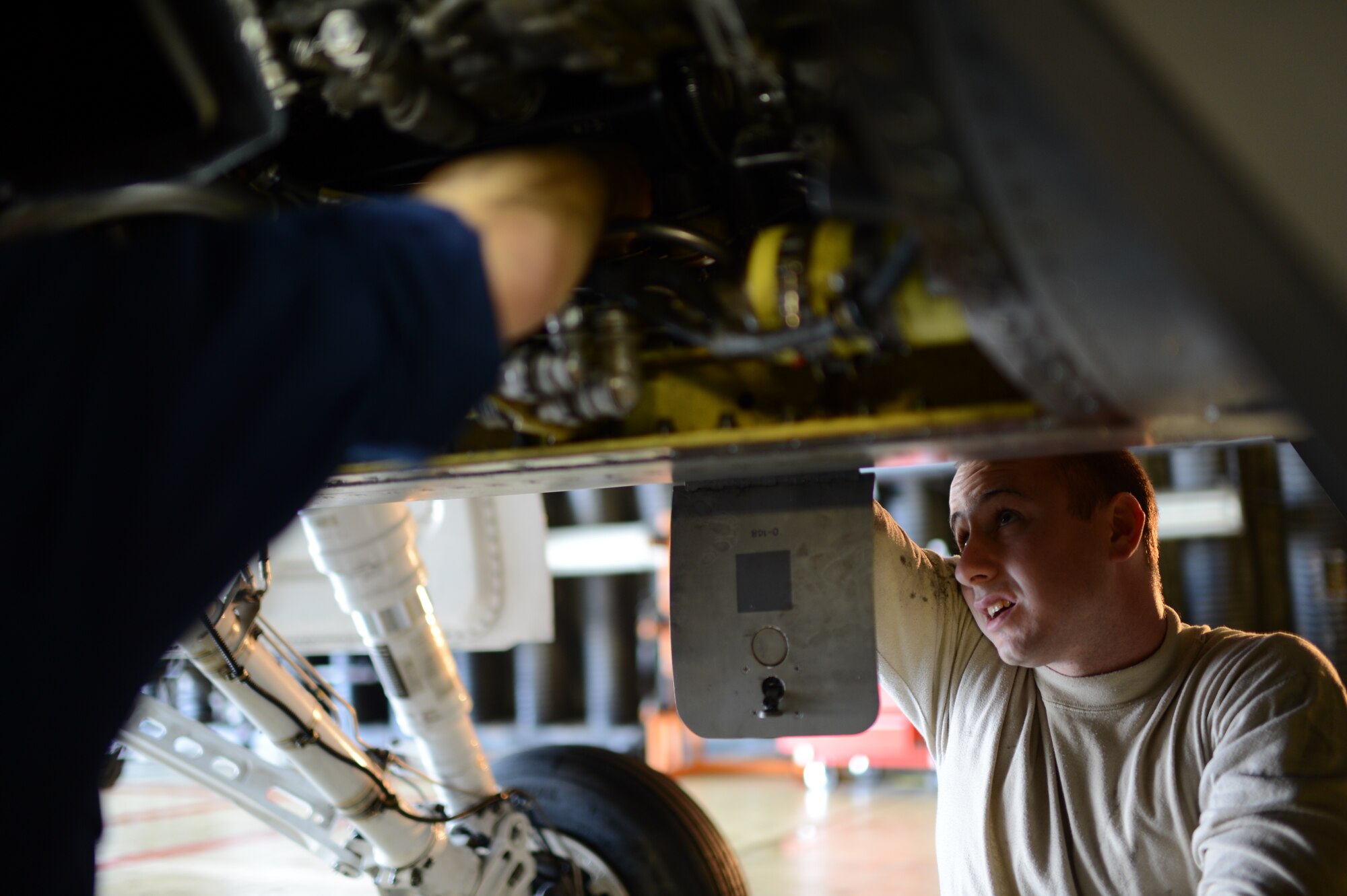 SPANGDAHLEM AIR BASE – U.S. Air Force Staff Sgt. James Speicher, 480th Aircraft Maintenance Unit cannibalization manager from Johnstown, Pa., assists in the cannibalization rebuild of an F-16 Fighting Falcon fighter aircraft Oct. 22, 2013.  A cannibalized aircraft is grounded and used for parts to fix other aircraft when no spare parts are available. (U.S. Air Force photo by Airman 1st Class Gustavo Castillo/Released) 