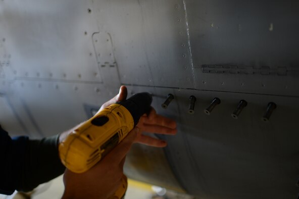 SPANGDAHLEM AIR BASE, Germany – U.S. Air Force Tech. Sgt. Brandon Fontaine, 480th Aircraft Maintenance Unit cannibalization manager from Erie, Pa., removes a panel from an F-16 Fighting Falcon fighter aircraft during a cannibalization rebuild Oct. 22, 2013. The 480th AMU grounded the aircraft six weeks for cannibalization. (U.S. Air Force photo by Airman 1st Class Gustavo Castillo/Released) 