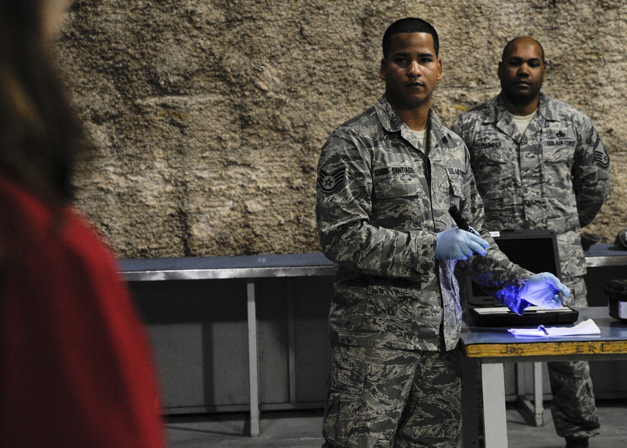Staff Sgt. Axel Lugo Santiago gives a nondestructive inspection demonstration during a Command Sponsorship Program tour at the 379th Air Expeditionary Wing in Southwest Asia, Oct. 23, 2013. The CSP leverages resources to improve support for families here and the tour familiarized families with the vast mission capabilities of the 379th AEW. Lugo Santiago is a 379th Expeditionary Maintenance Squadron NDI technician deployed from Seymour Johnson Air Force Base, N.C., and a Carolina, Puerto Rico, native. 