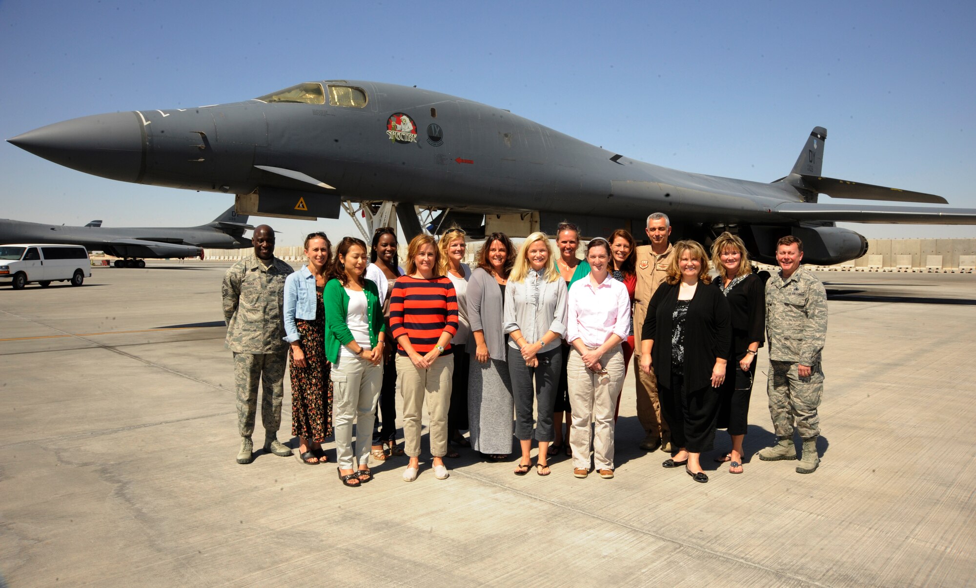 Military spouses pose with 379th Air Expeditionary Wing leaders during a Command Sponsorship Program tour at the 379th AEW in Southwest Asia, Oct. 23, 2013. The CSP is an accompanied-tour initiative started in 2011 to increase mission effectiveness through extended permanent party presence, greater mission continuity and fewer burdens on families. (U.S. Air Force photo/Senior Airman Bahja J. Jones)