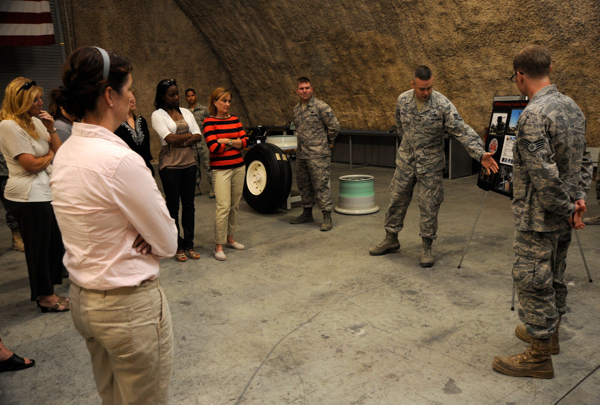 Military spouses receive a mission brief on Airfield Battle Damage Recovery during a Command Sponsorship Program tour at the 379th Air Expeditionary Wing in Southwest Asia, Oct. 23, 2013. The CSP is an accompanied-tour initiative started in 2011 to increase mission effectiveness through extended permanent party presence, greater mission continuity and fewer burdens on families. (U.S. Air Force photo/Senior Airman Bahja J. Jones)